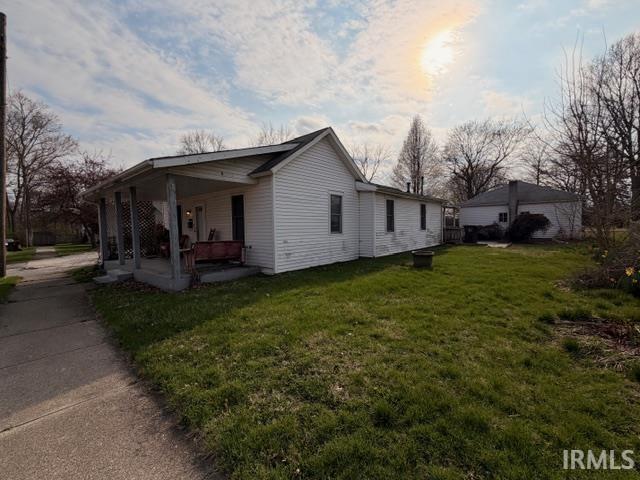 View of home's exterior with a yard