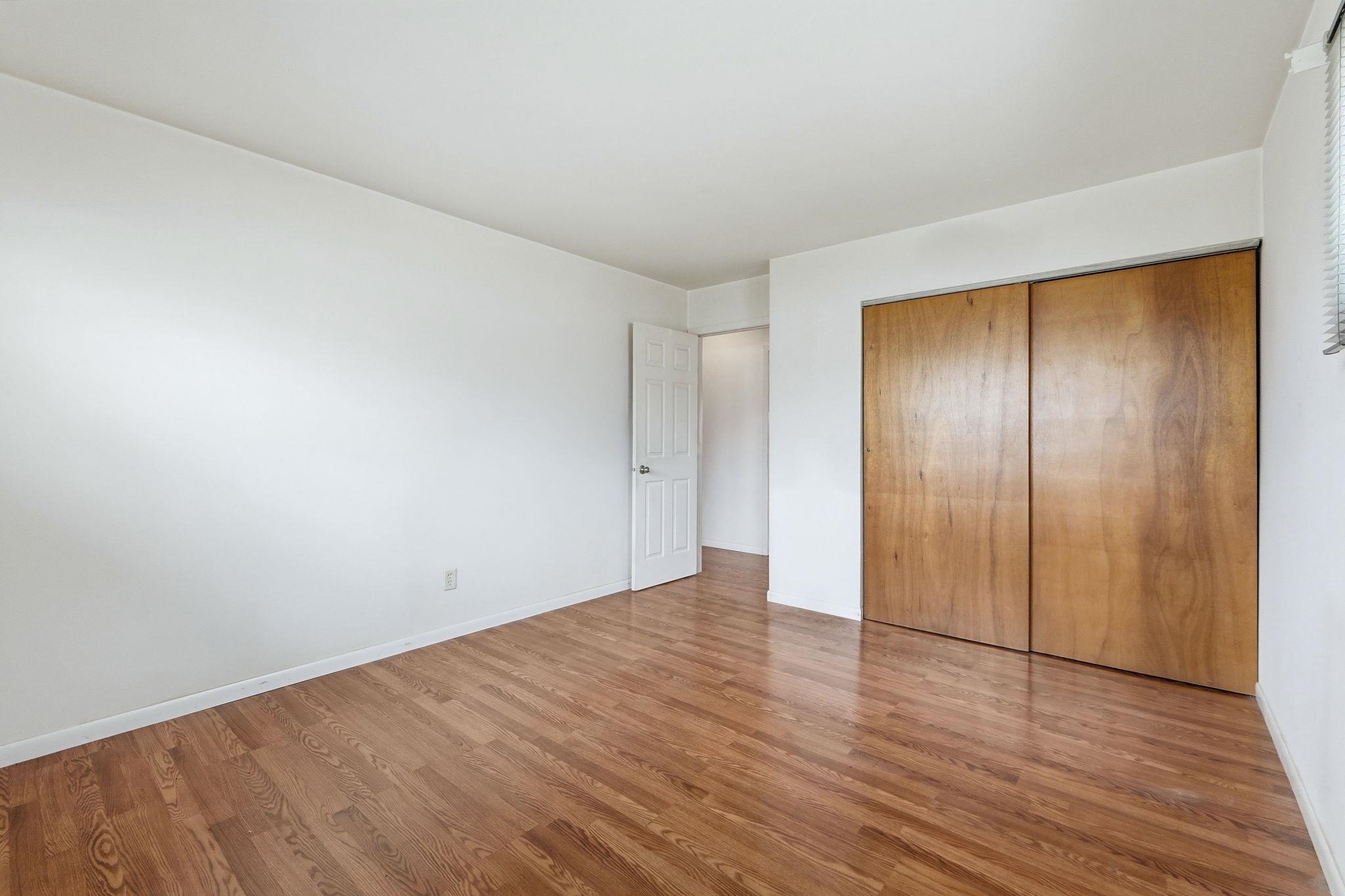 Unfurnished bedroom featuring a closet and light wood-style floors