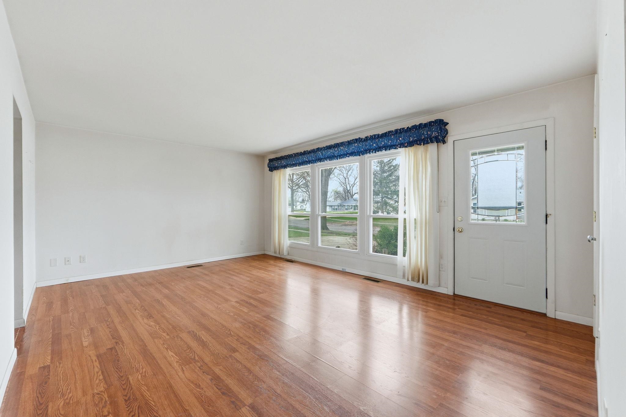 Foyer with light wood-type flooring and baseboards