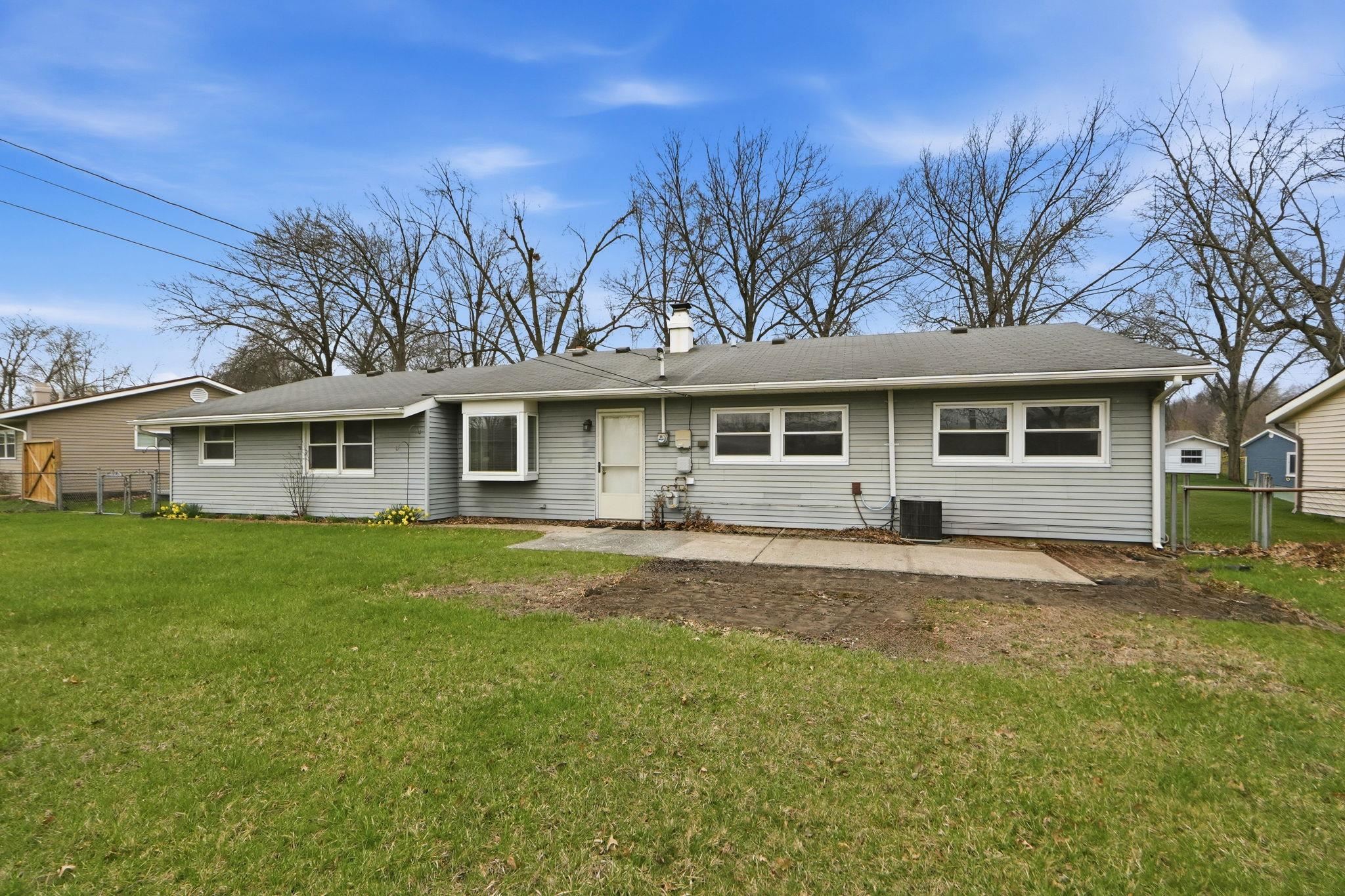 View of front of property with a patio area and a chimney