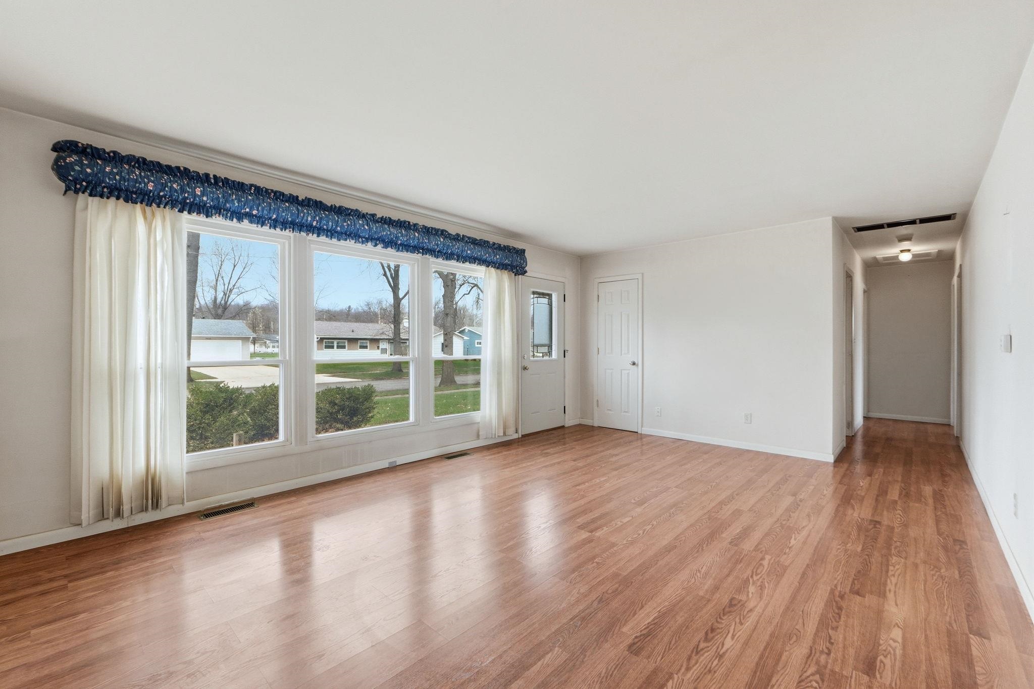Spare room featuring light wood-style floors and baseboards
