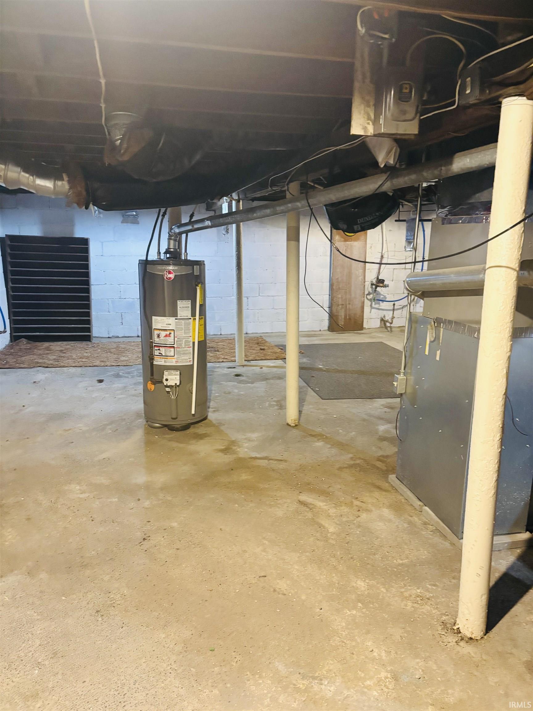 Unfinished below grade area with water heater and heating unit