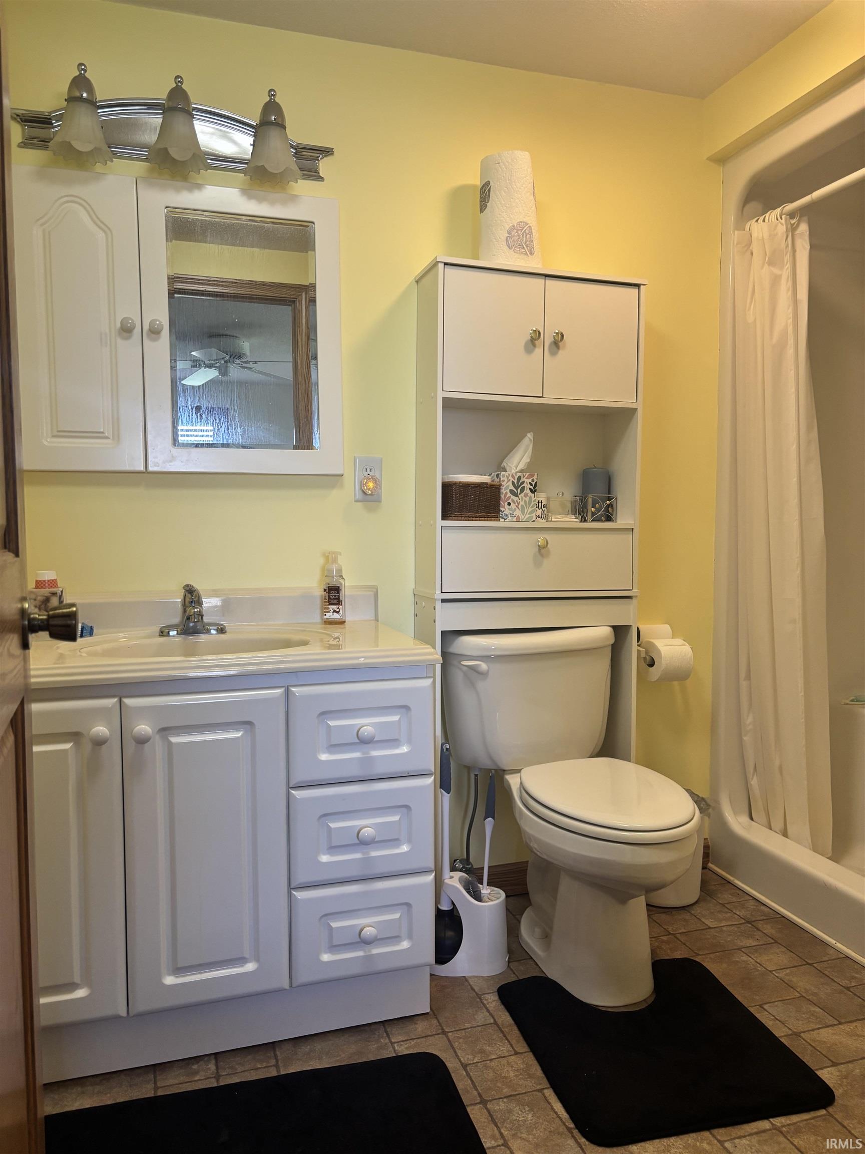 Bathroom with a stall shower and vanity