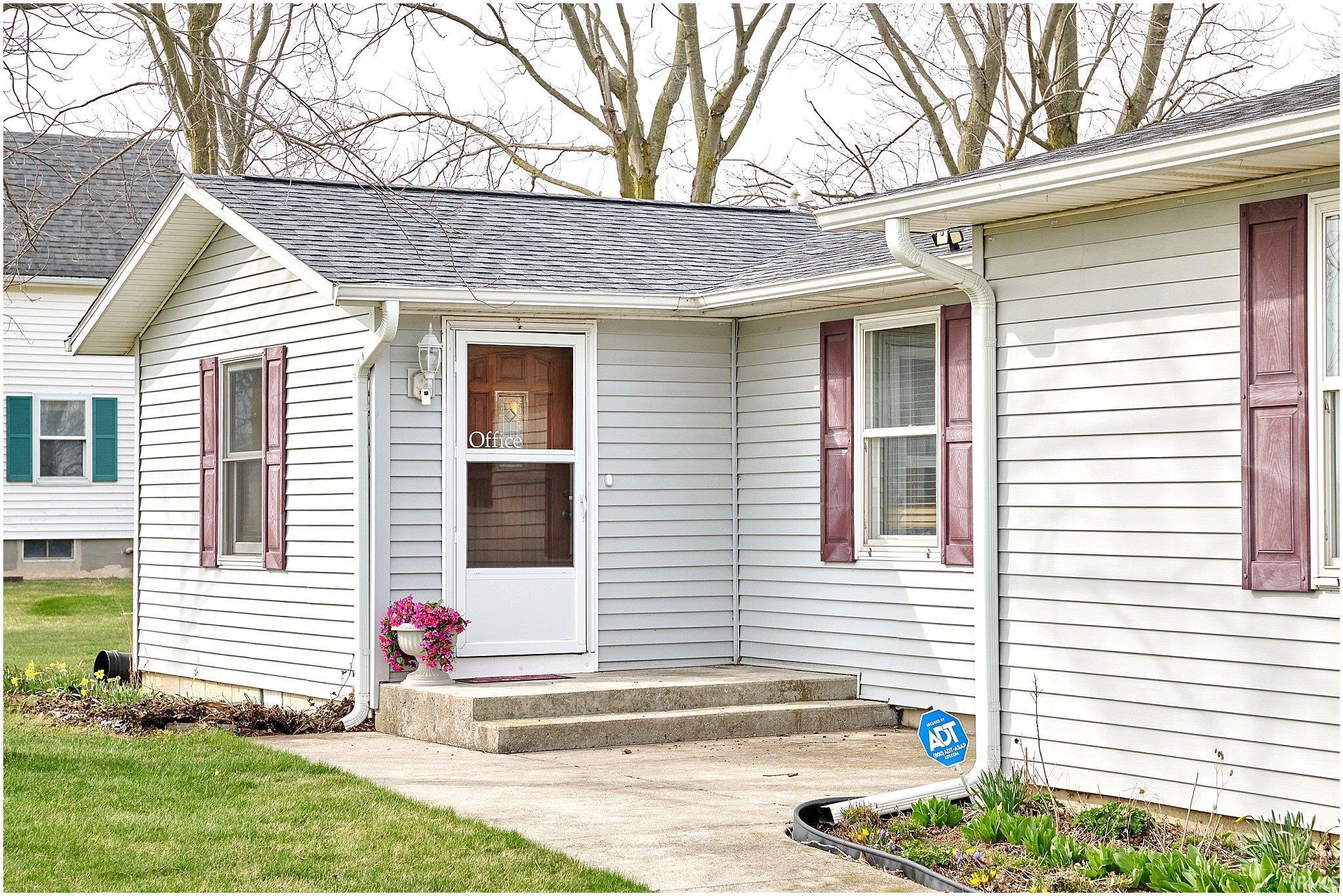 Property entrance featuring roof with shingles