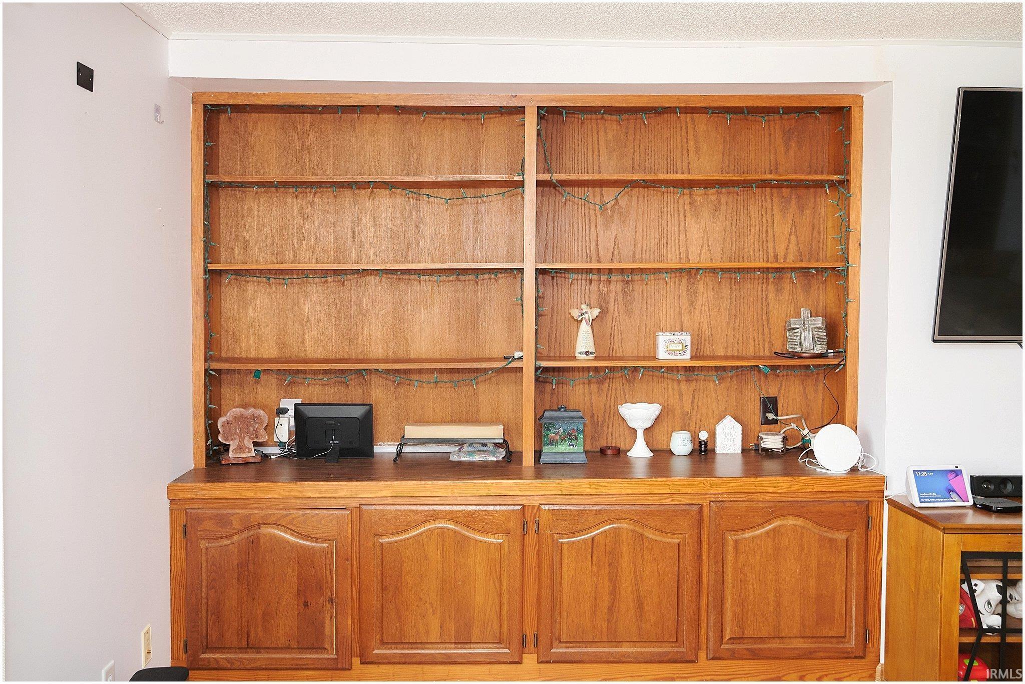 Bar area featuring wood finish cabinetry and a textured ceiling