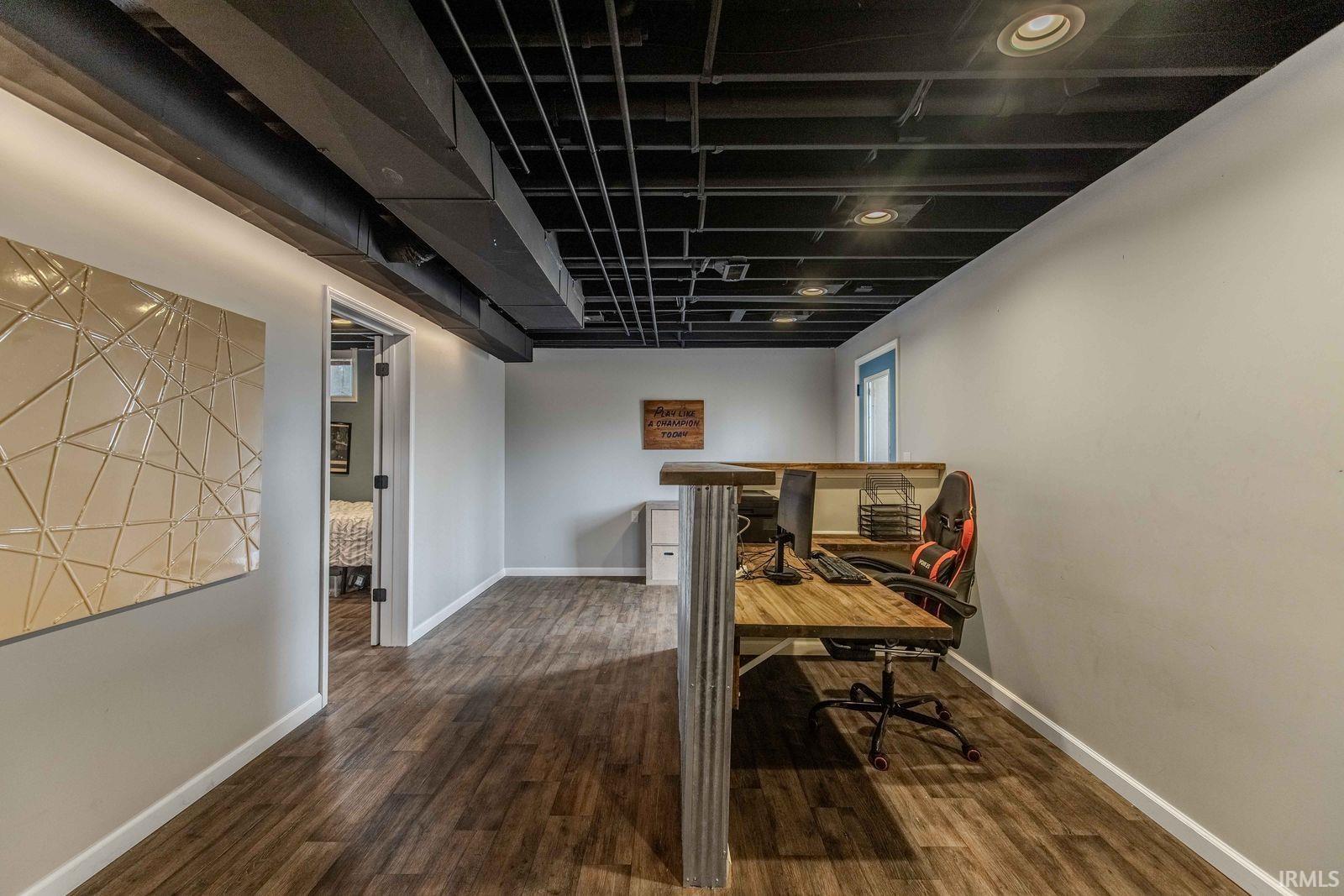 Office space with dark wood-style flooring