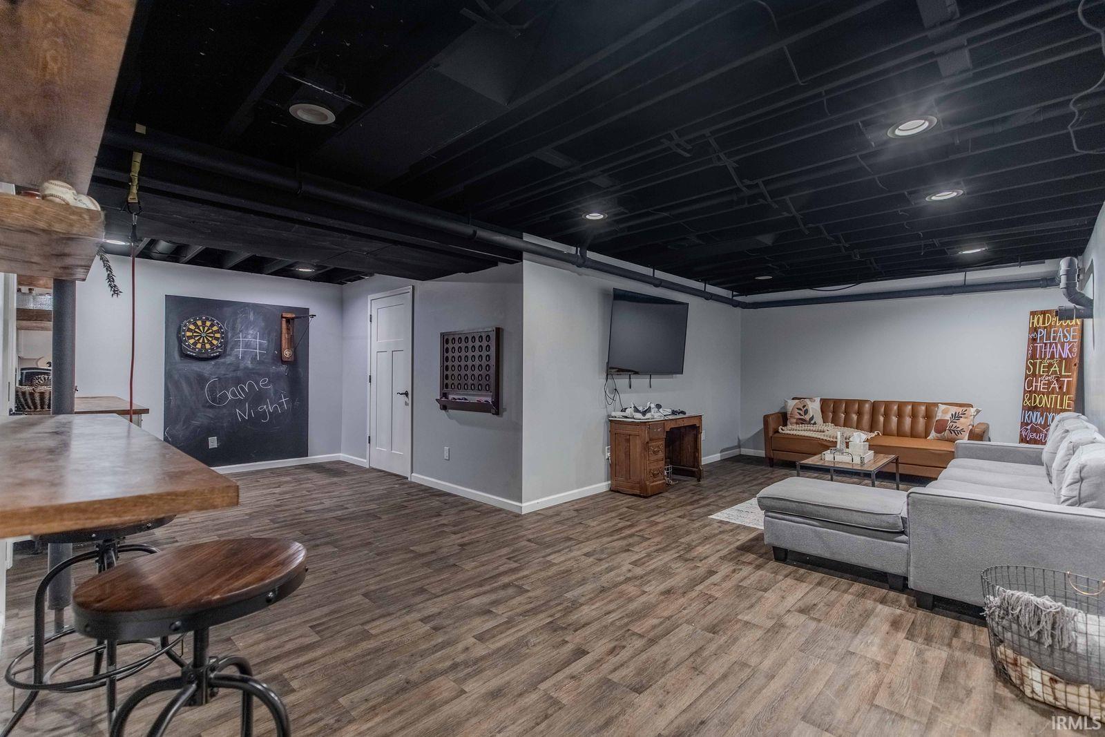 Living area featuring wood finished floors and recessed lighting