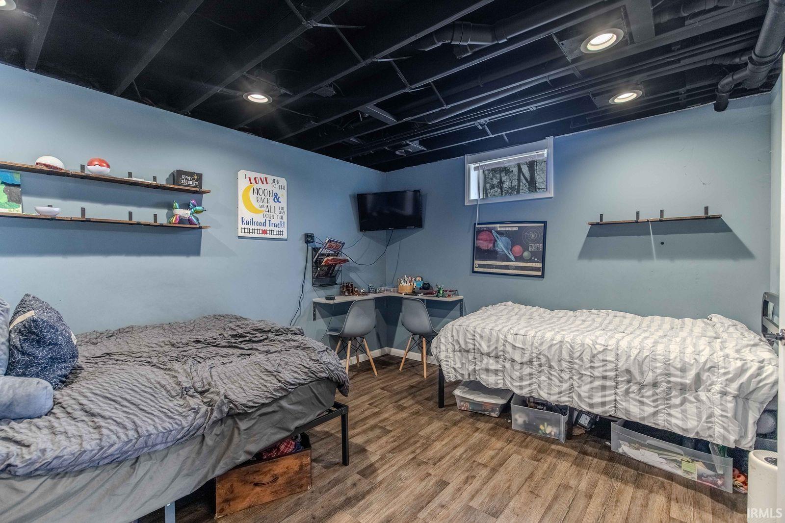 Bedroom featuring wood finished floors, an office area, and recessed lighting