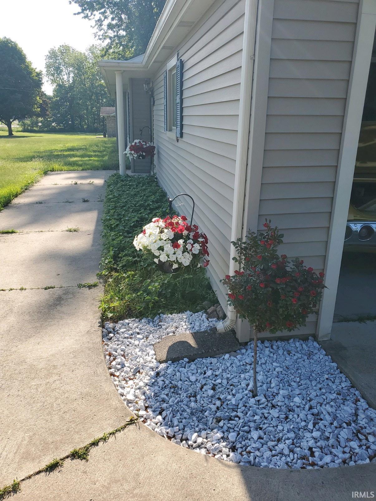View of side of property featuring a lawn