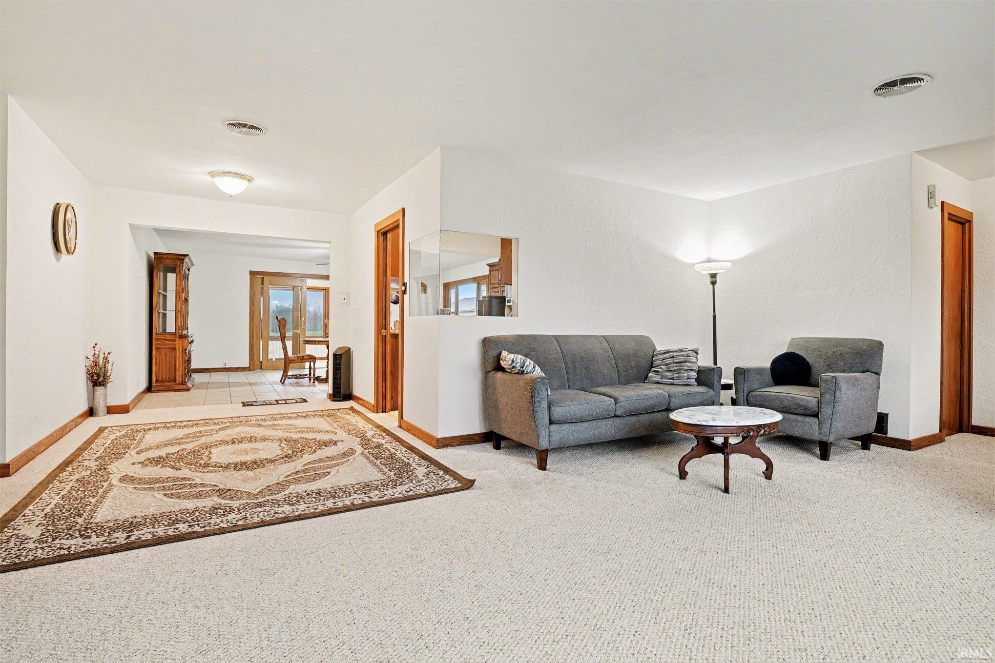 Living room featuring light carpet and baseboards