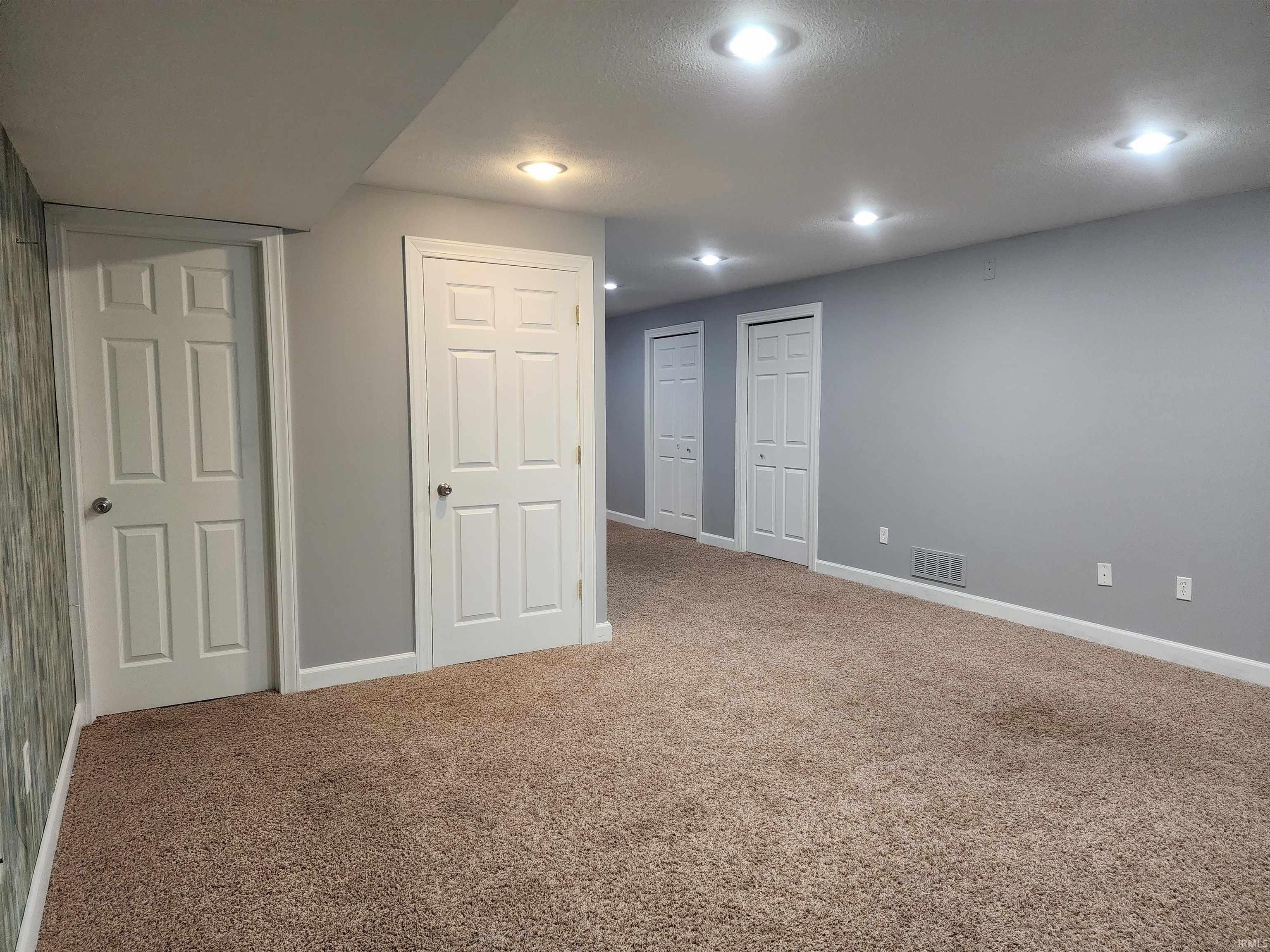 Below grade area featuring baseboards and carpet