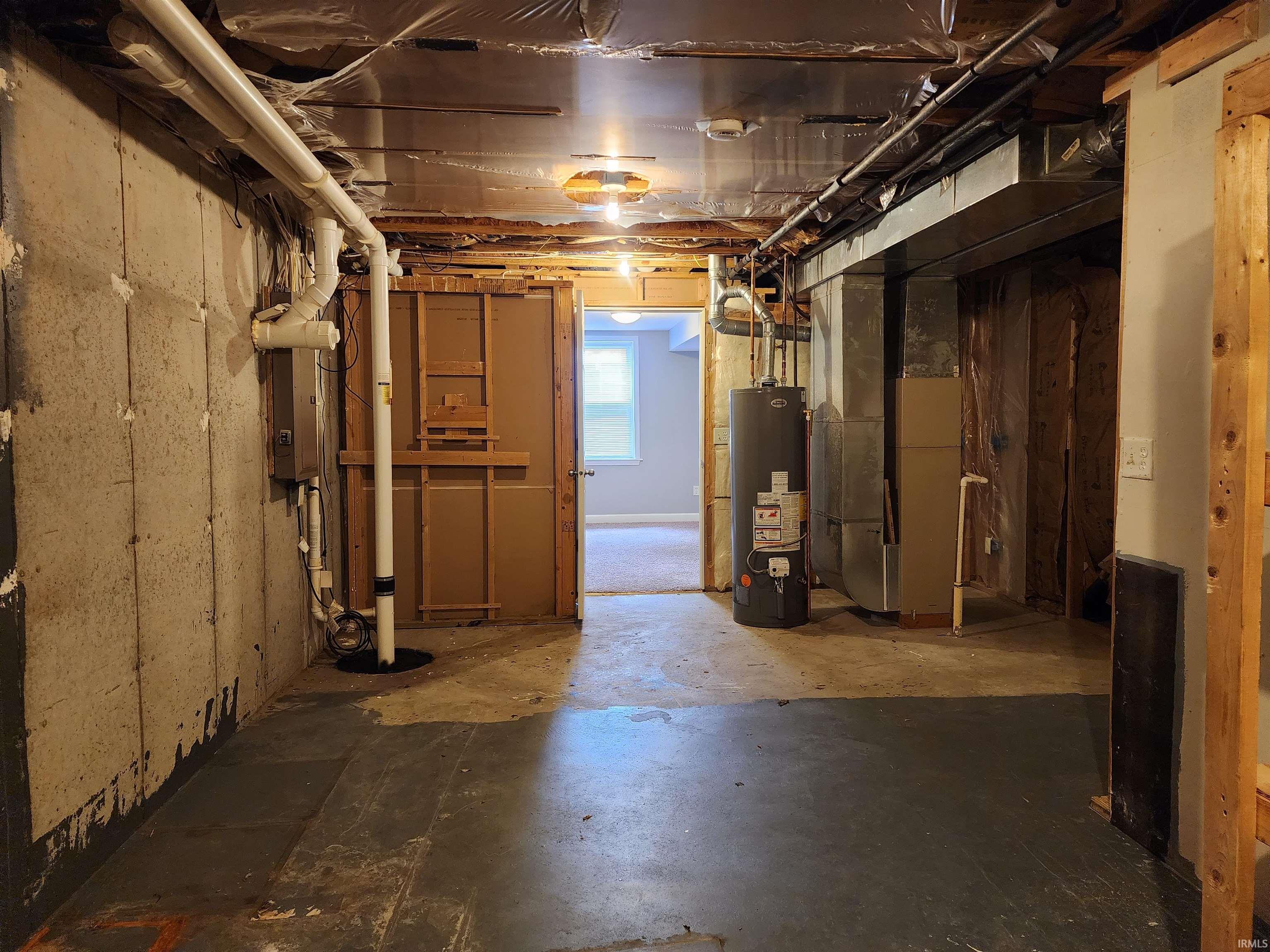 Basement featuring heating unit and water heater