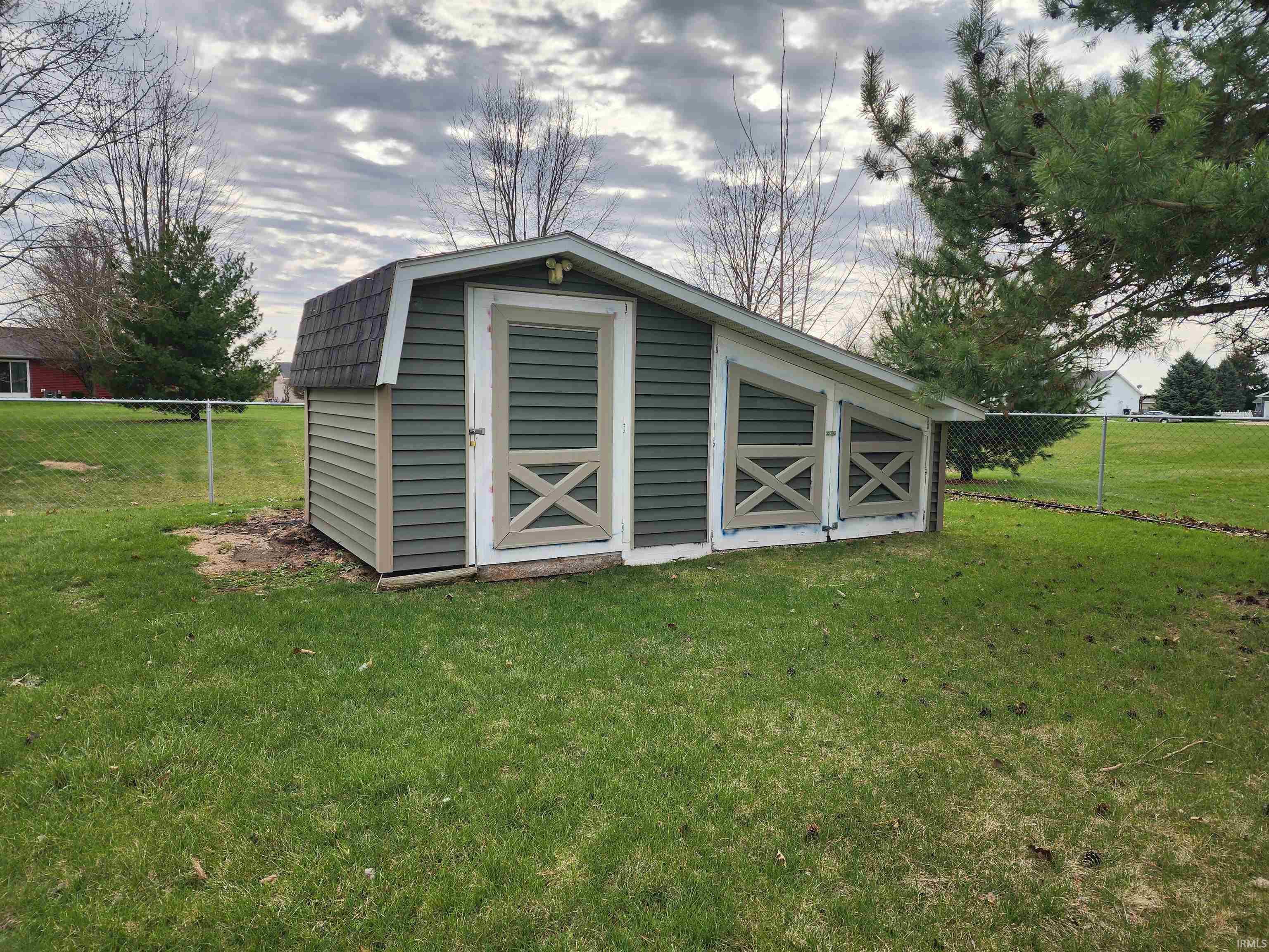 View of shed with a fenced backyard