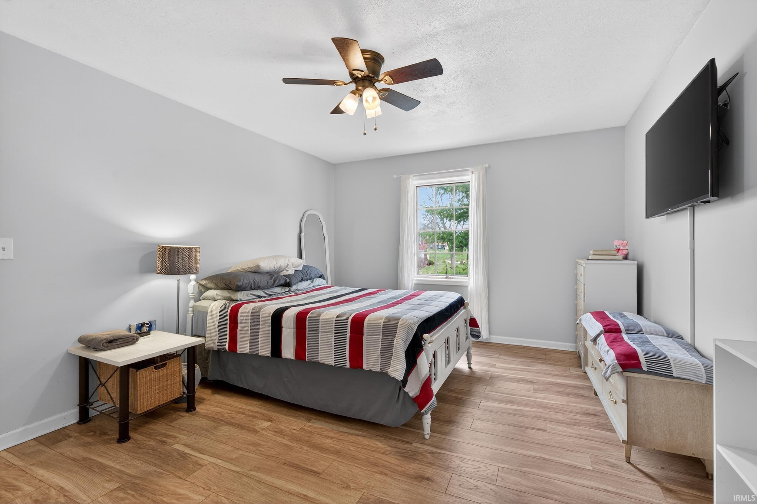 Bedroom with light wood finished floors and ceiling fan