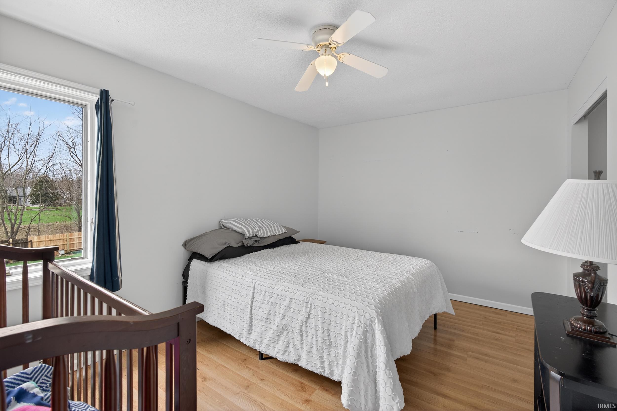 Bedroom featuring light wood-type flooring and a ceiling fan