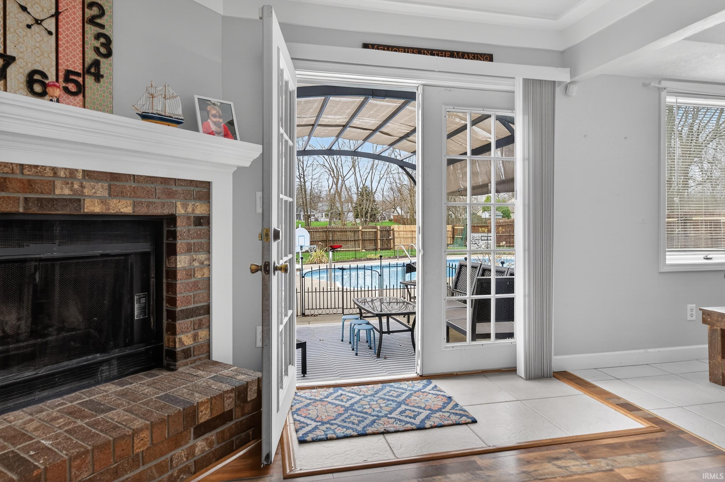 Doorway featuring a fireplace and baseboards