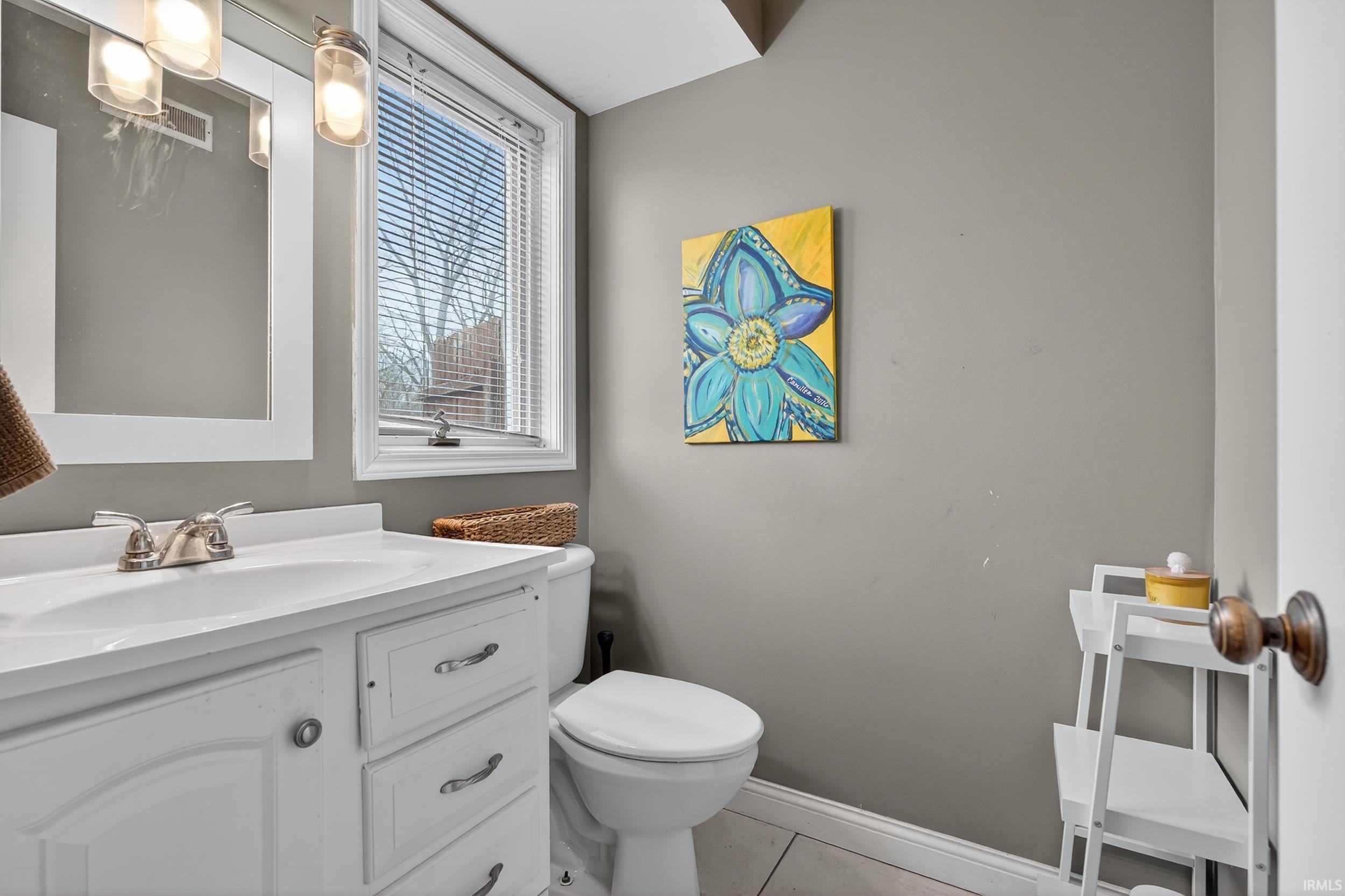 Bathroom with vanity and light tile patterned floors