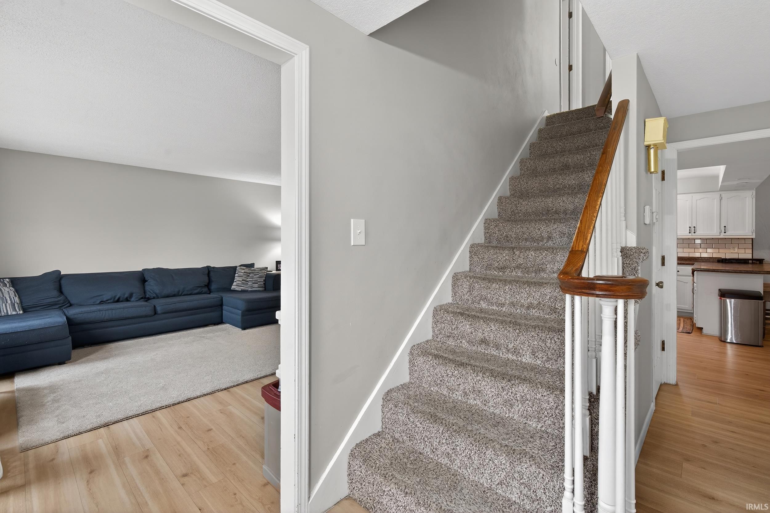 Staircase featuring wood finished floors