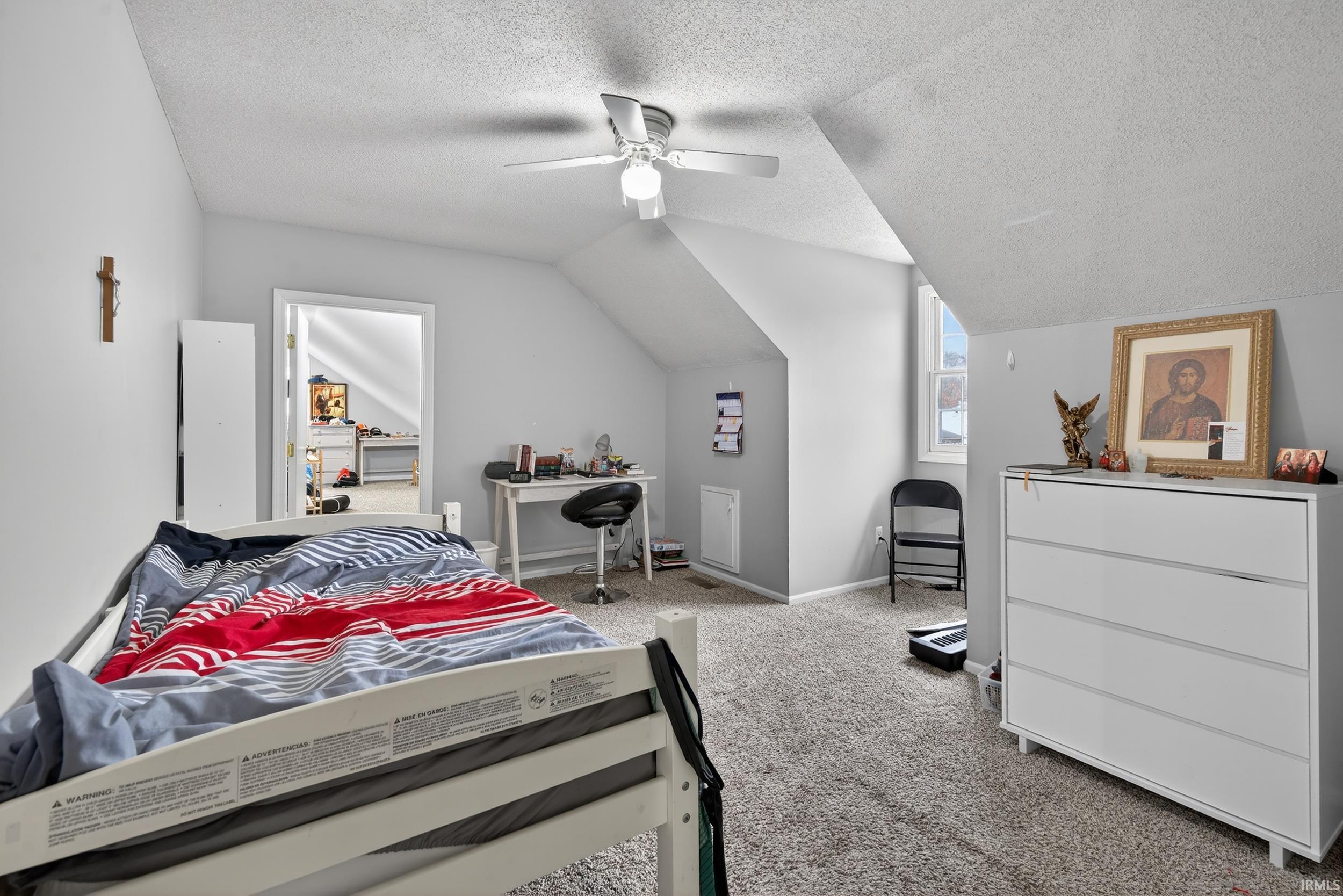 Bedroom with carpet and a ceiling fan