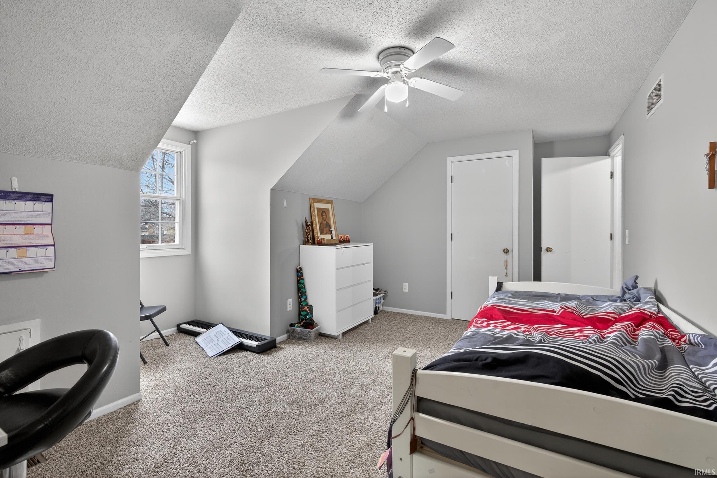 Bedroom featuring light colored carpet and ceiling fan