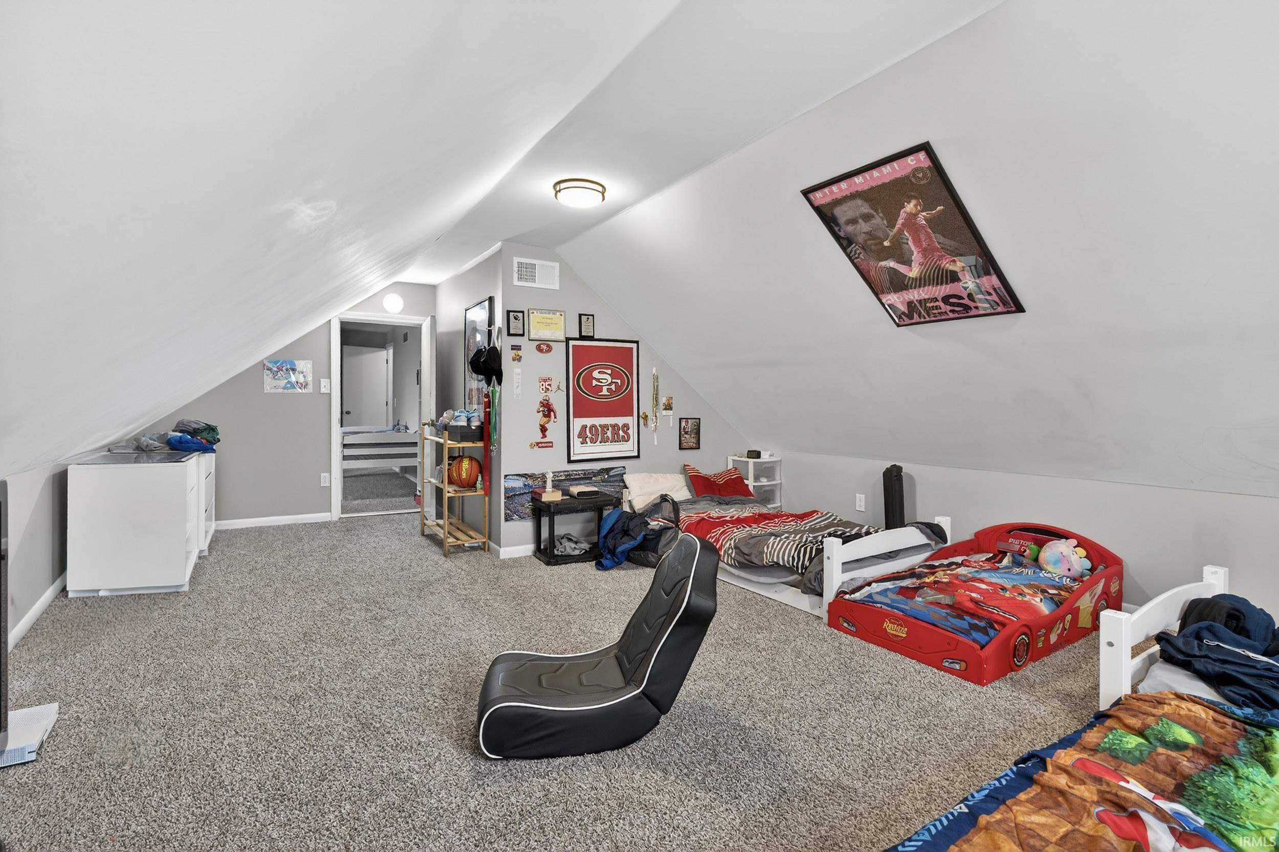 Bedroom featuring carpet flooring and baseboards