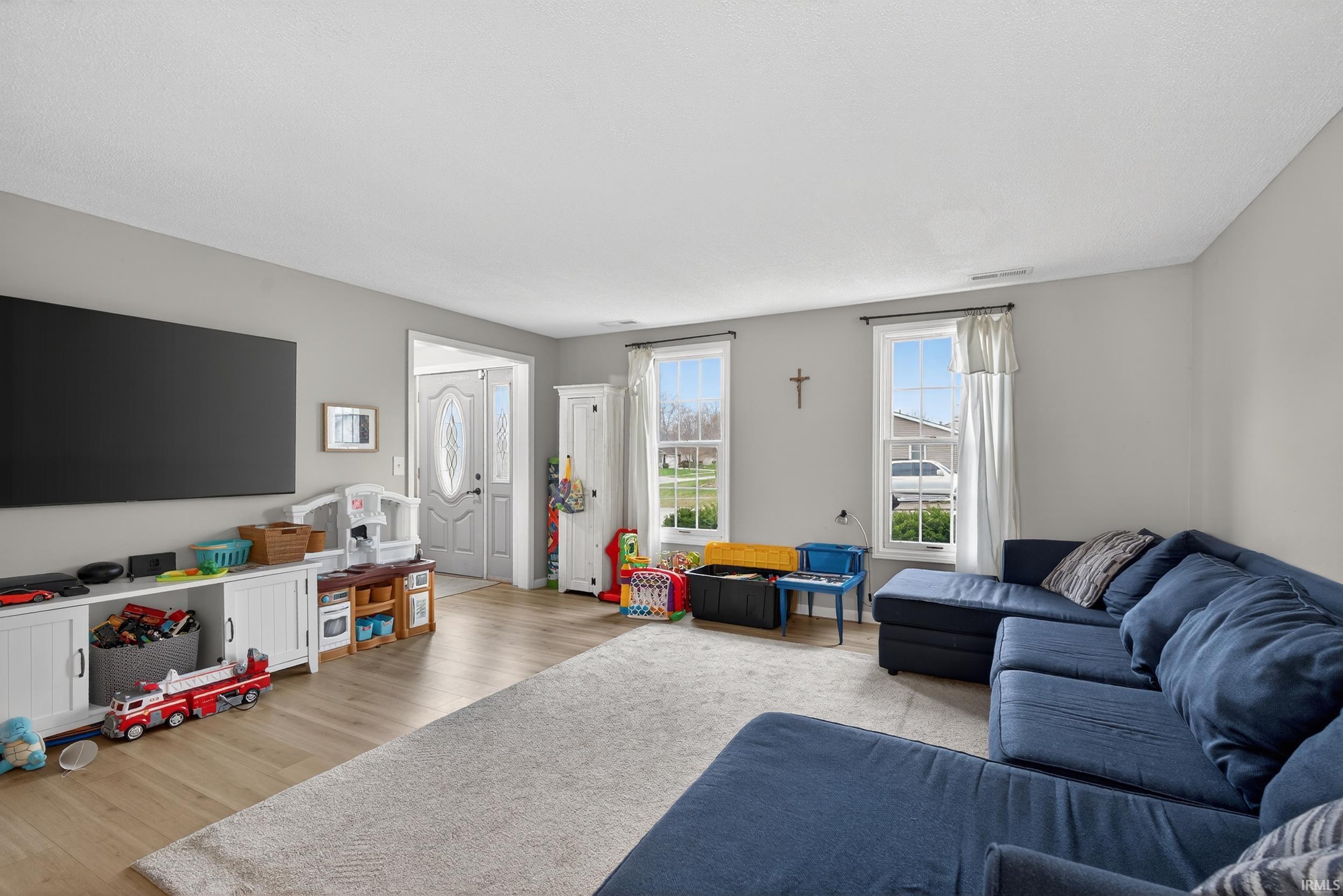 Living room with light wood-type flooring