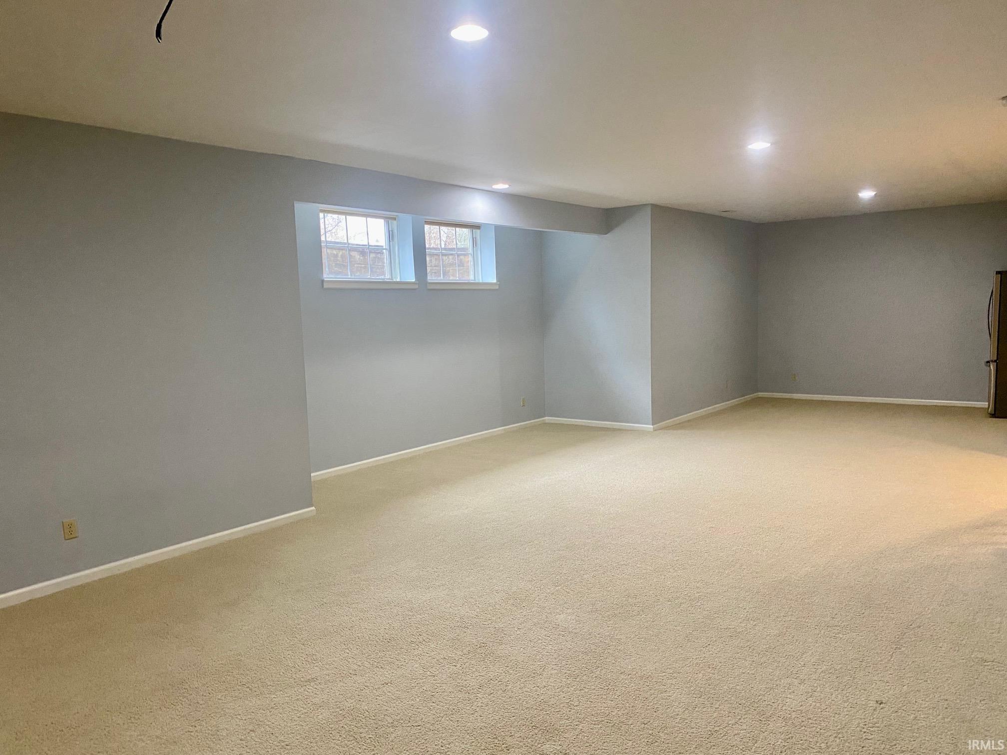 Below grade area featuring light carpet and recessed lighting