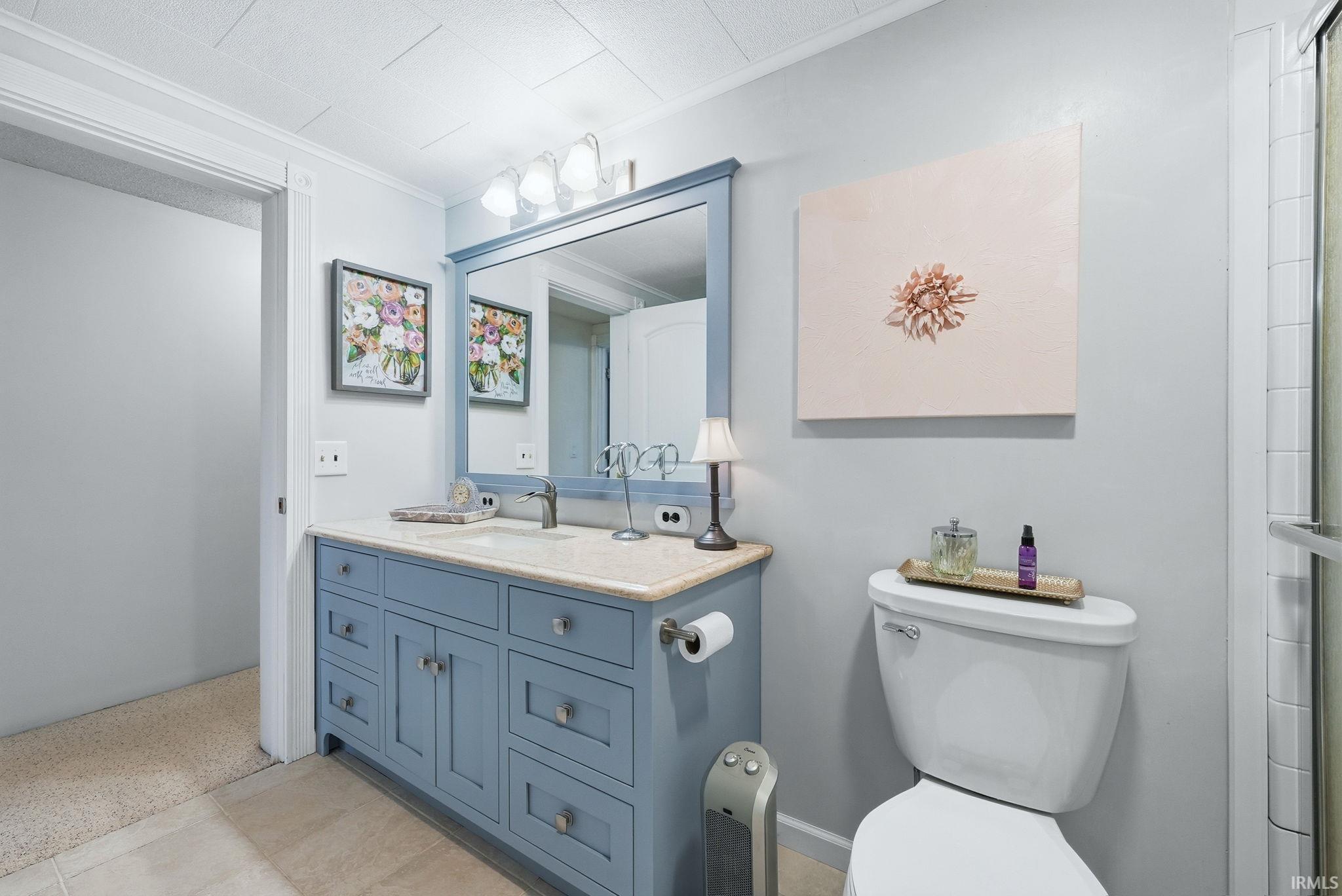 Bathroom featuring vanity and crown molding