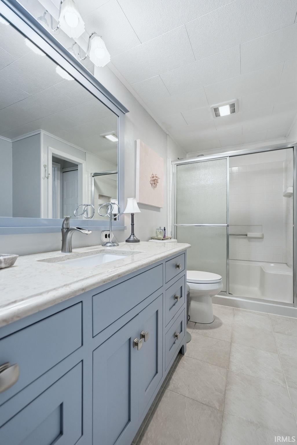 Full bathroom featuring vanity and a stall shower