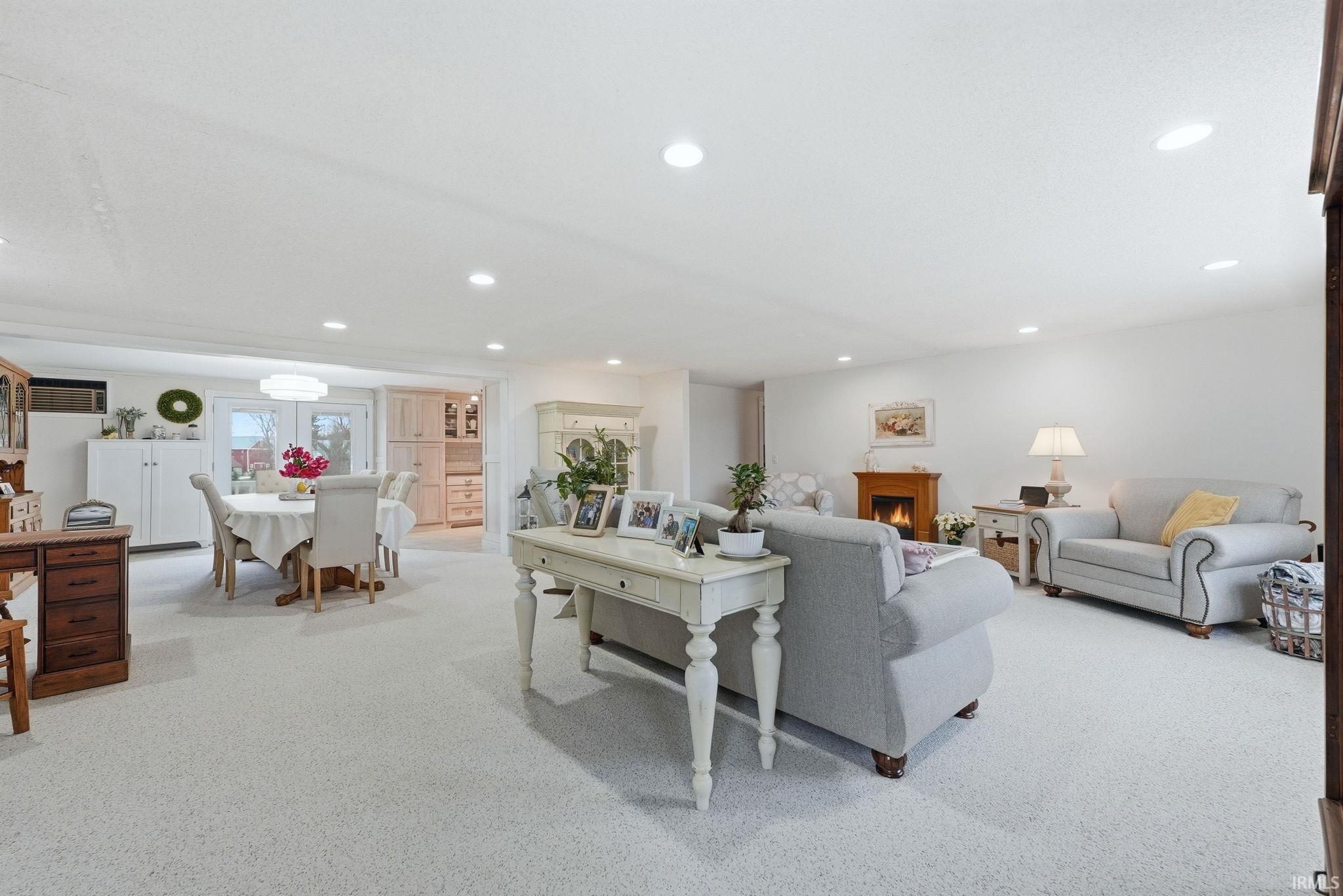 Living room featuring light colored carpet and recessed lighting