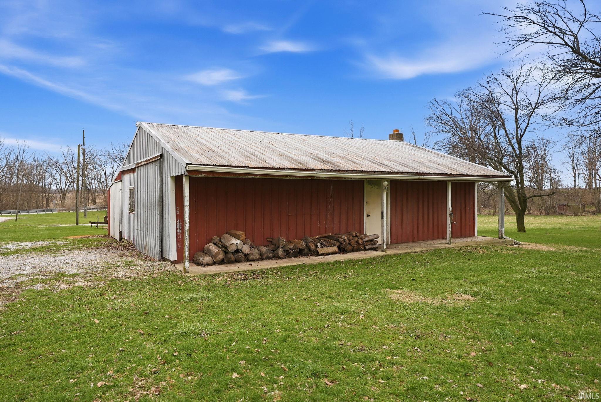View of pole building with a lawn