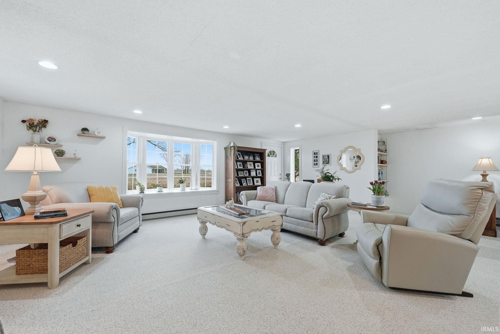Living room with light carpet and recessed lighting
