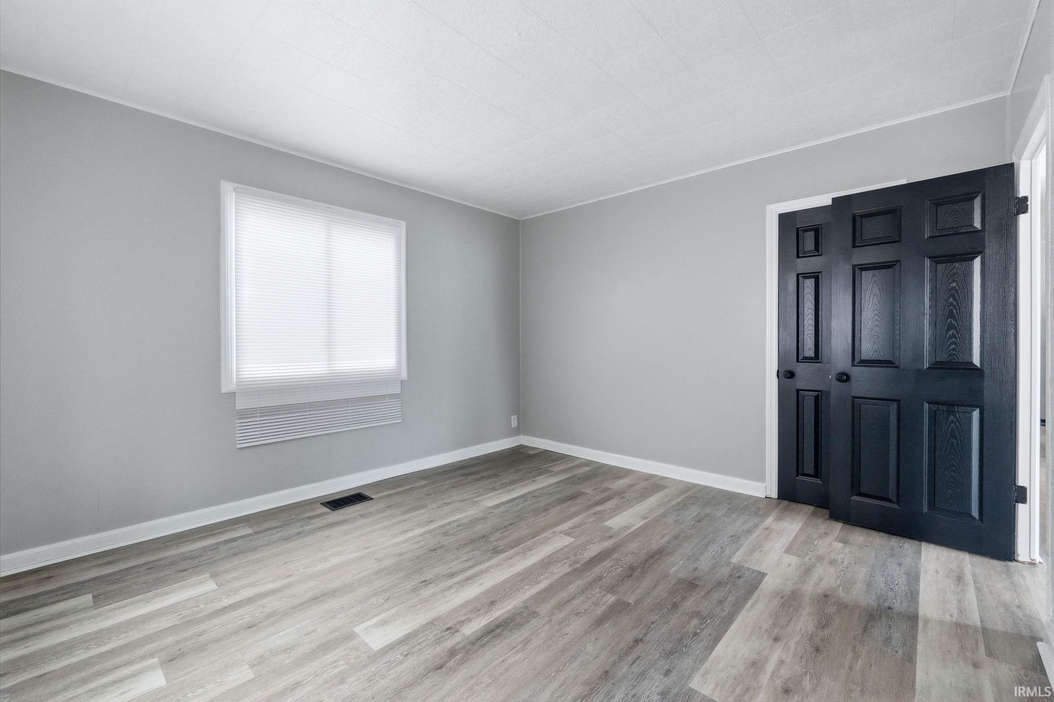 Spare room featuring light wood-style flooring