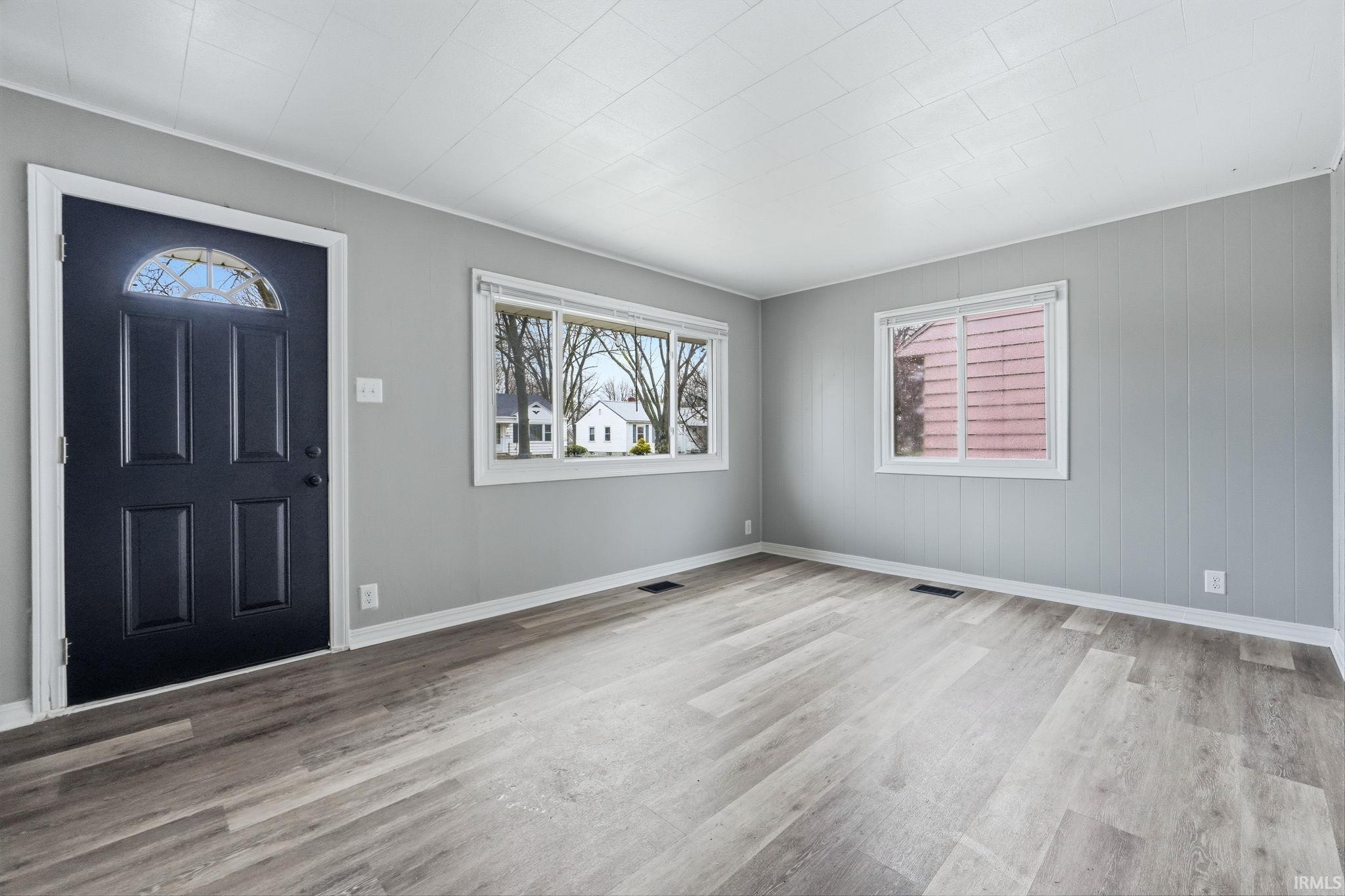 Foyer featuring plenty of natural light and light wood-style floors