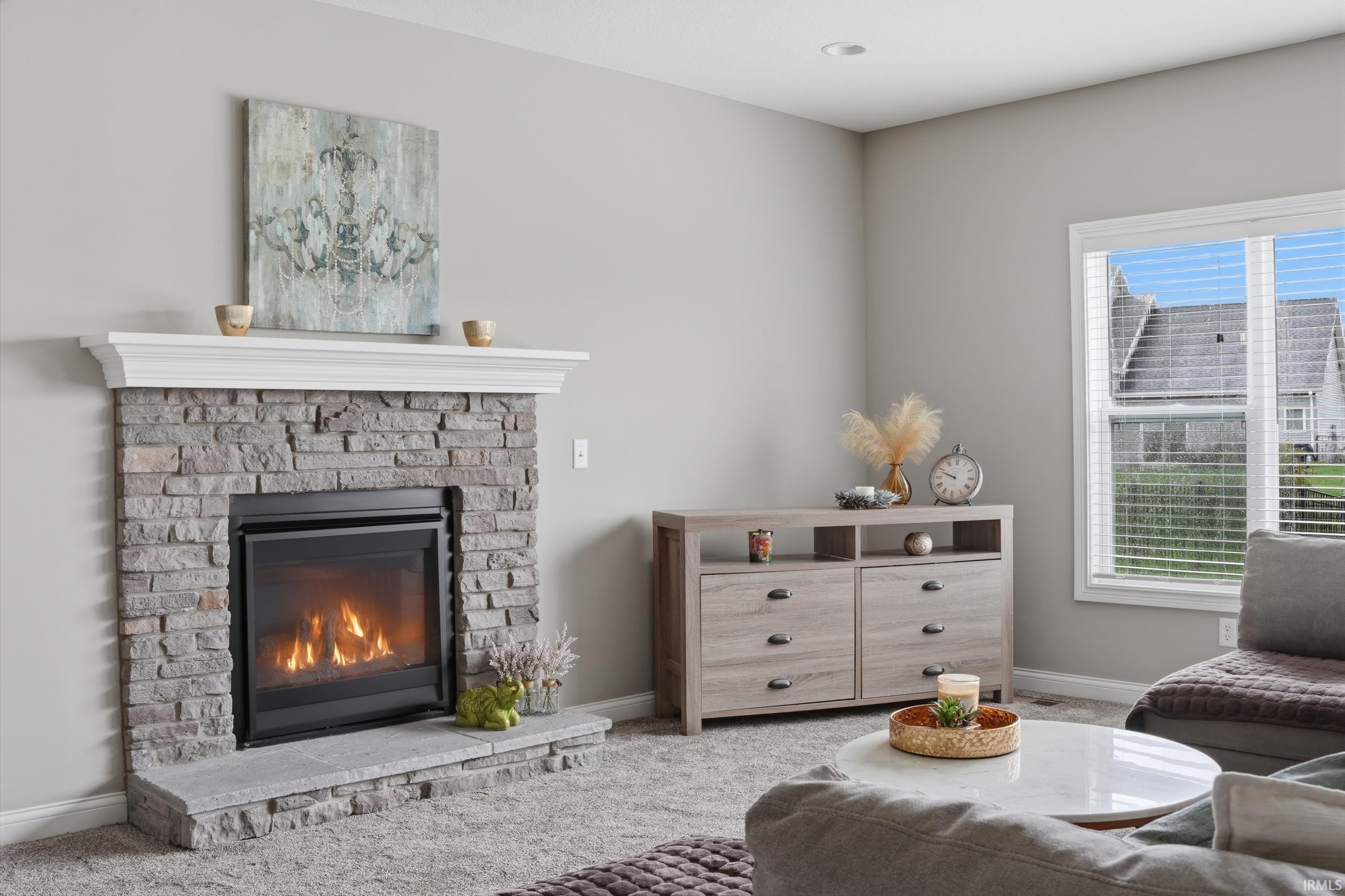 Living room featuring carpet flooring and a brick fireplace