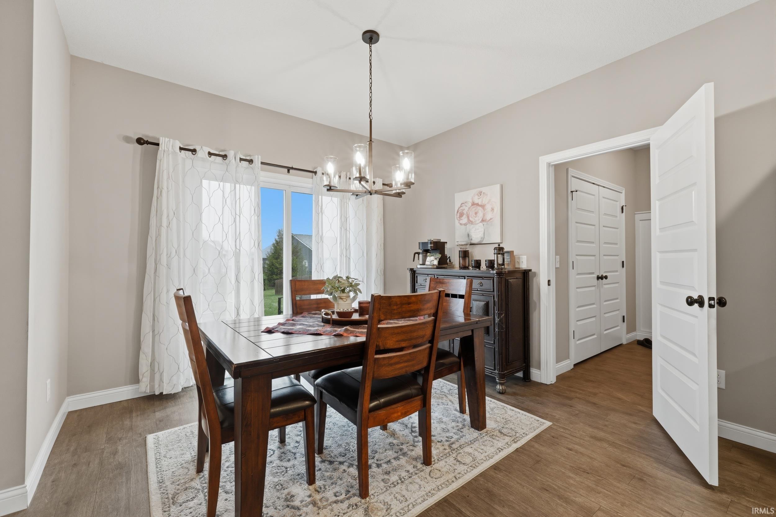 Dining area featuring a chandelier and wood finished floors