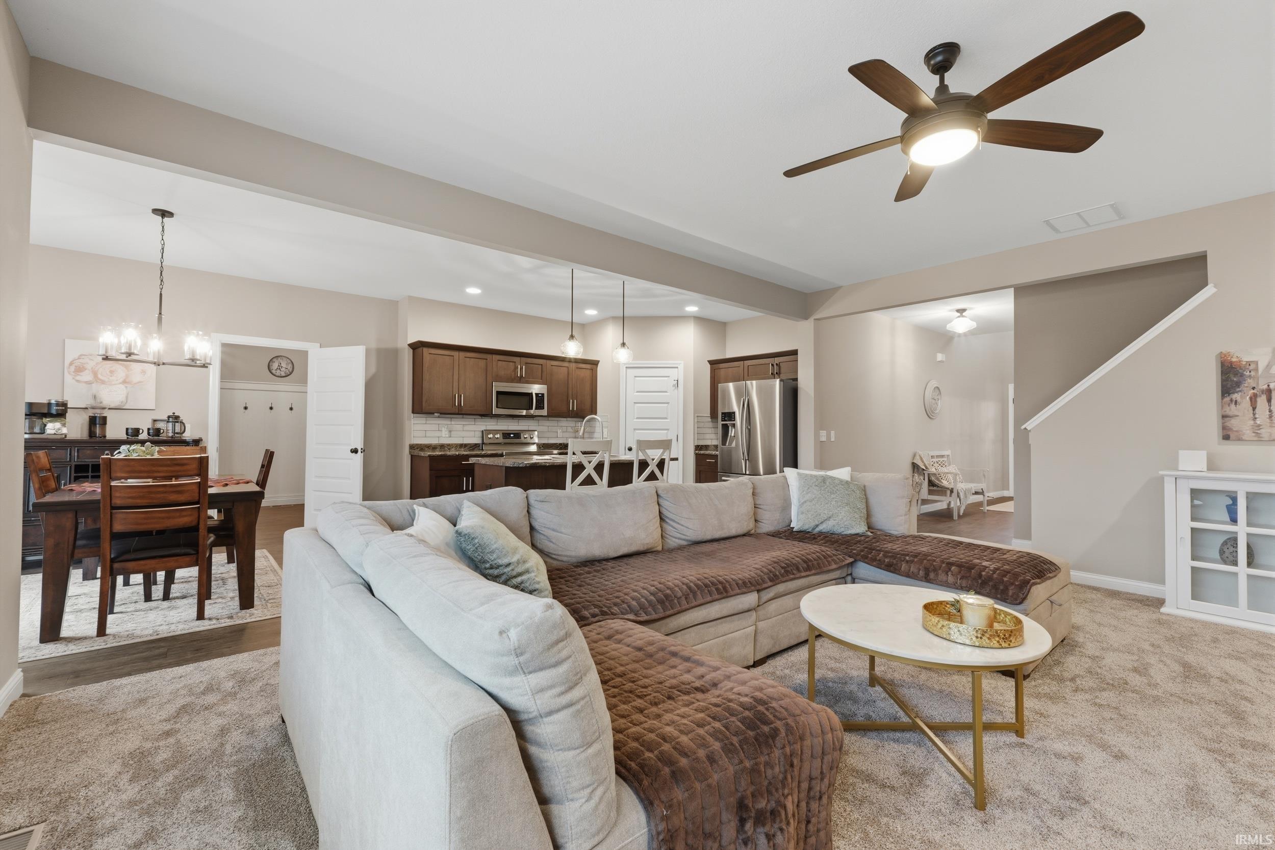 Living room with hanging lights and ceiling fan