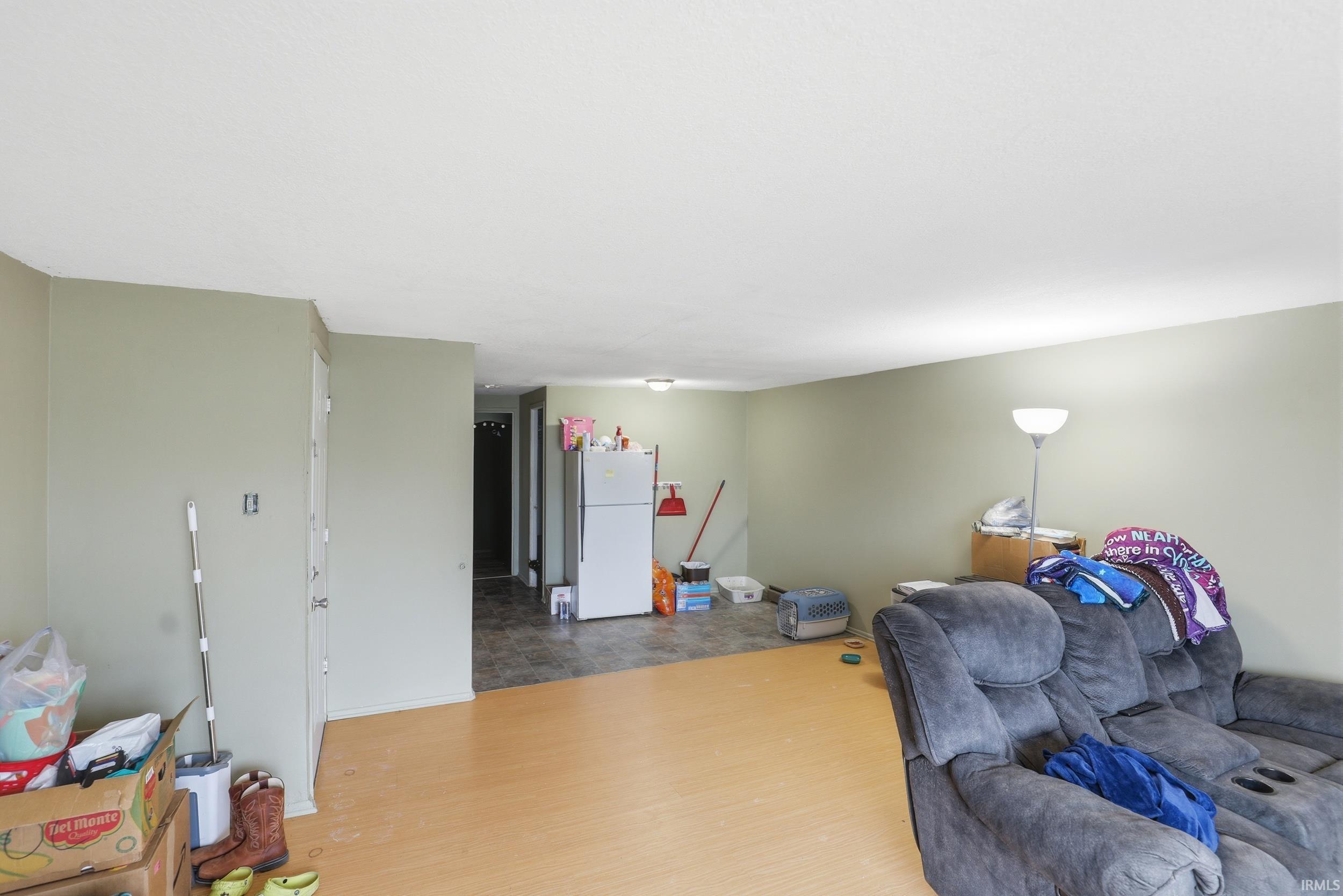 Living area with baseboards and wood finished floors