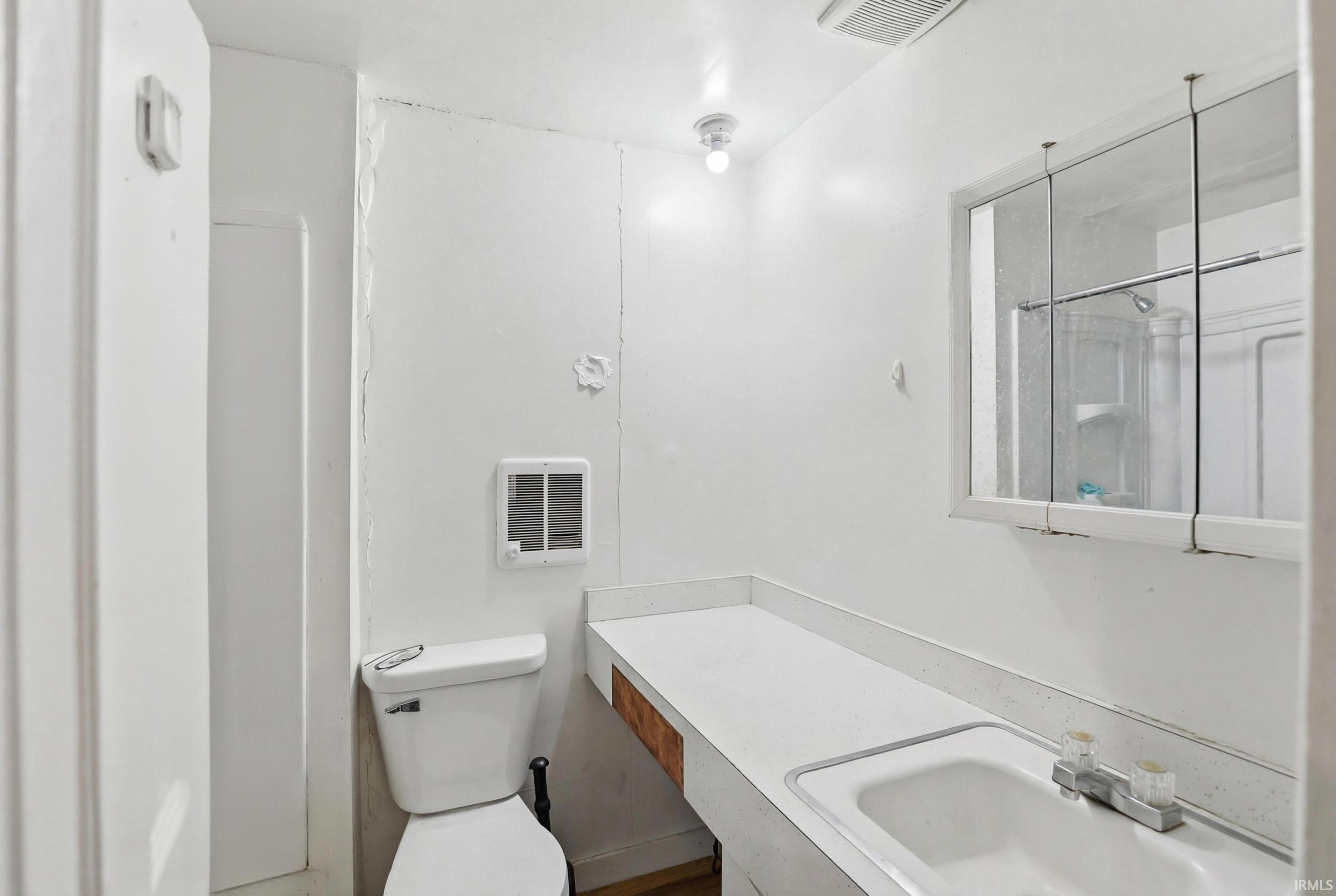 Bathroom featuring vanity and heating unit