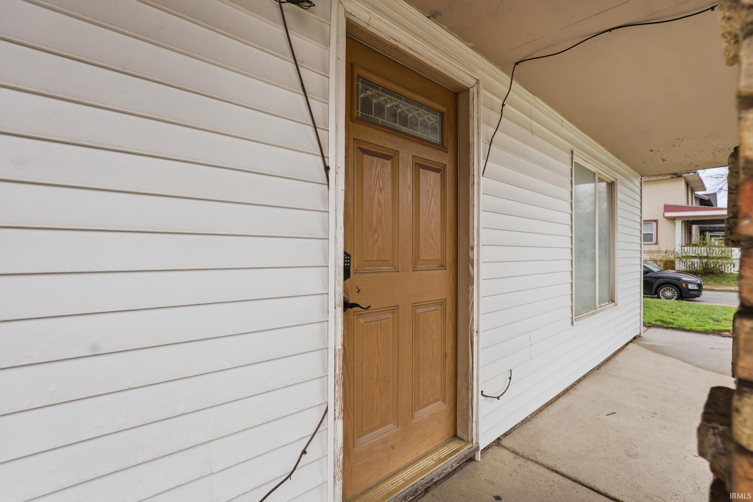 View of exterior entry with a porch