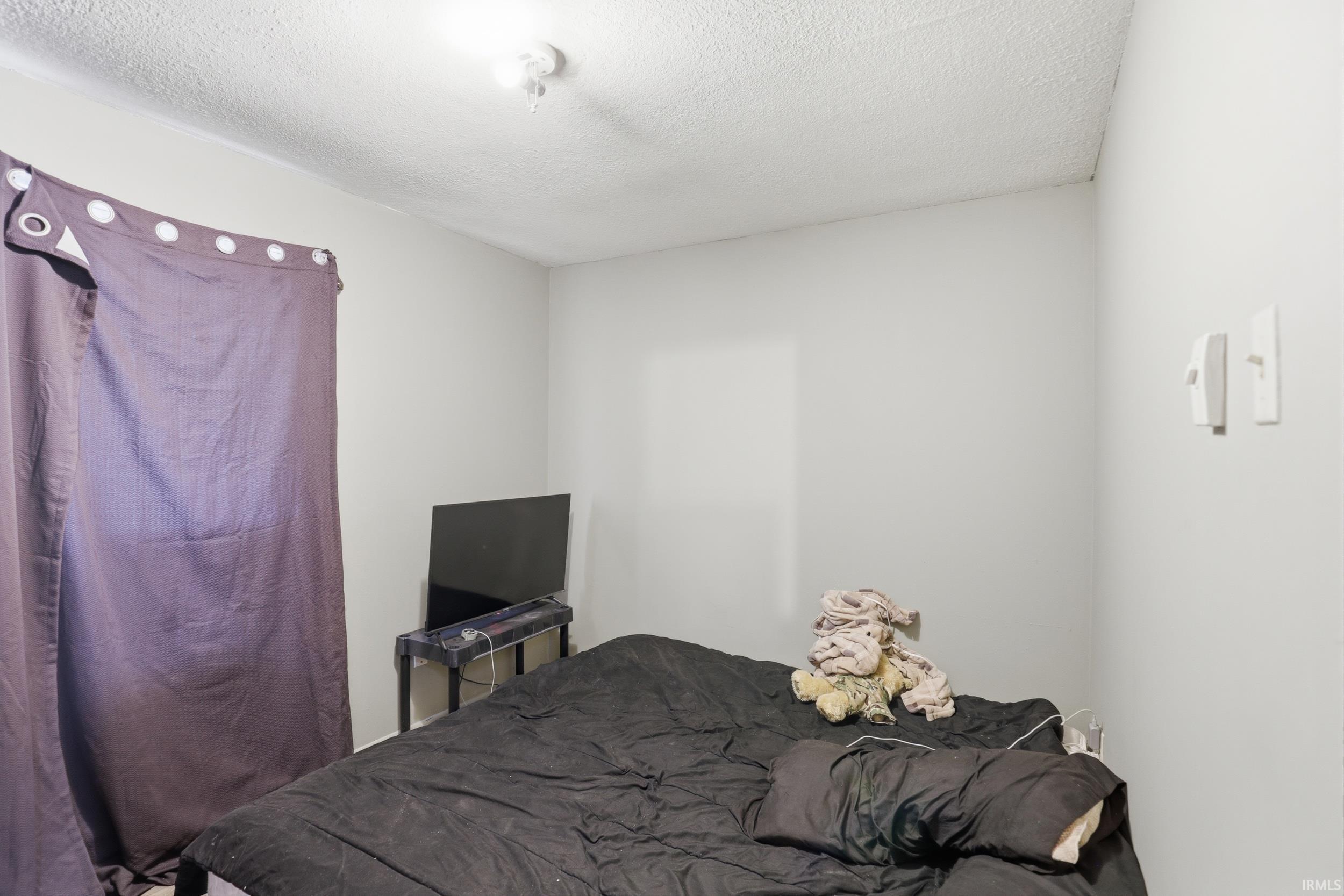 Bedroom with a textured ceiling