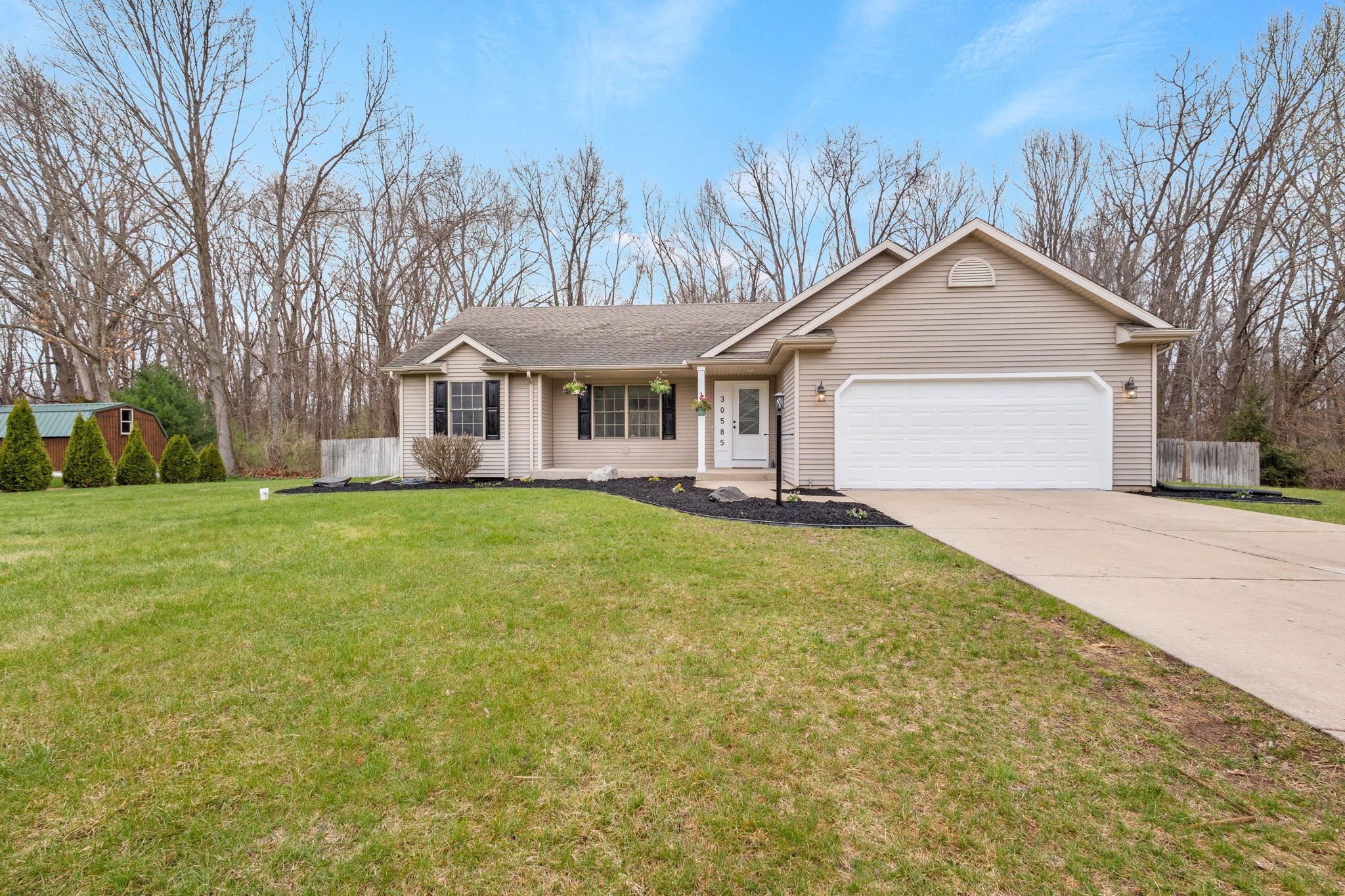 Ranch-style home with a garage and concrete driveway