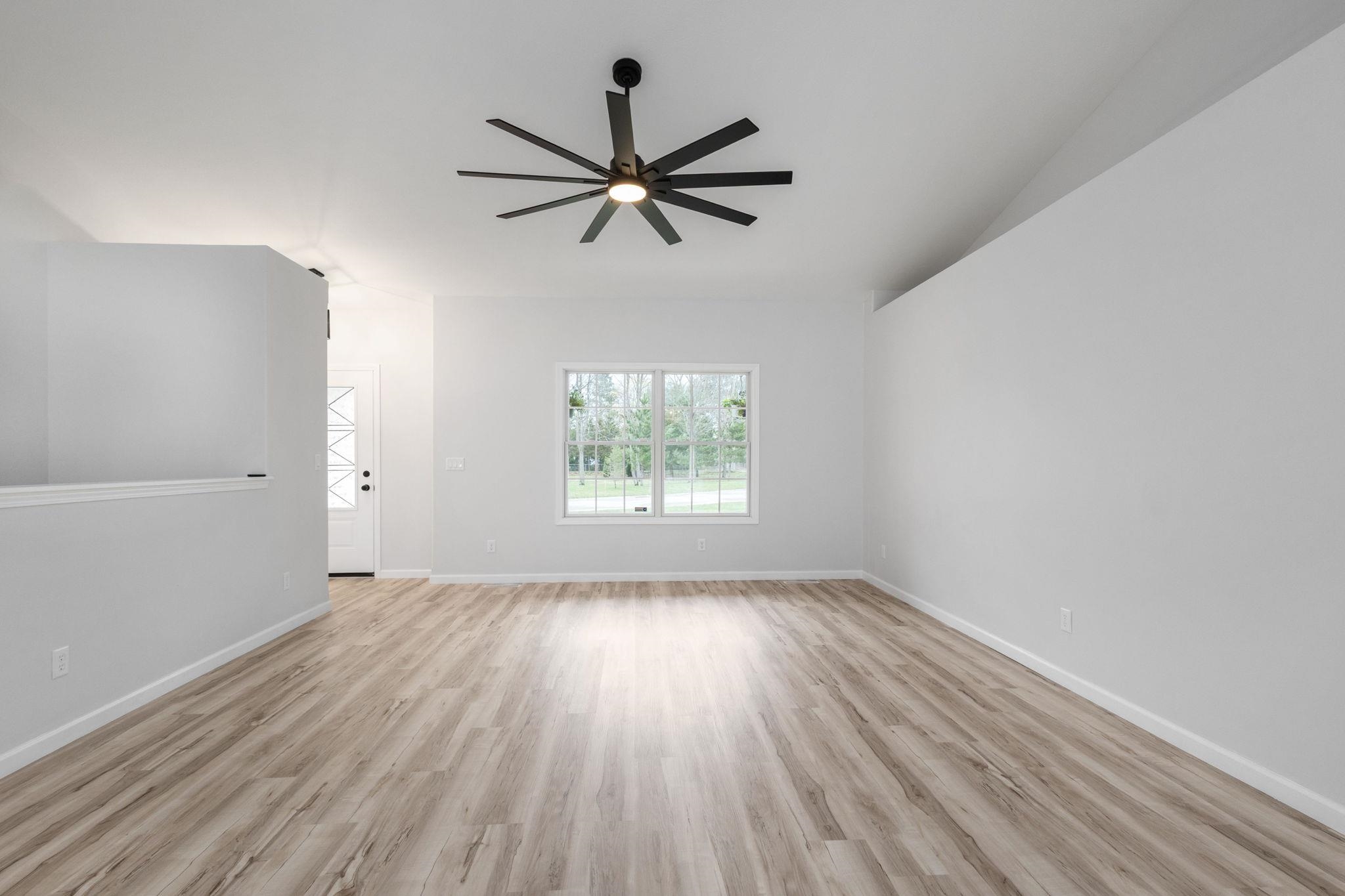 Spare room featuring light wood-style floors and ceiling fan