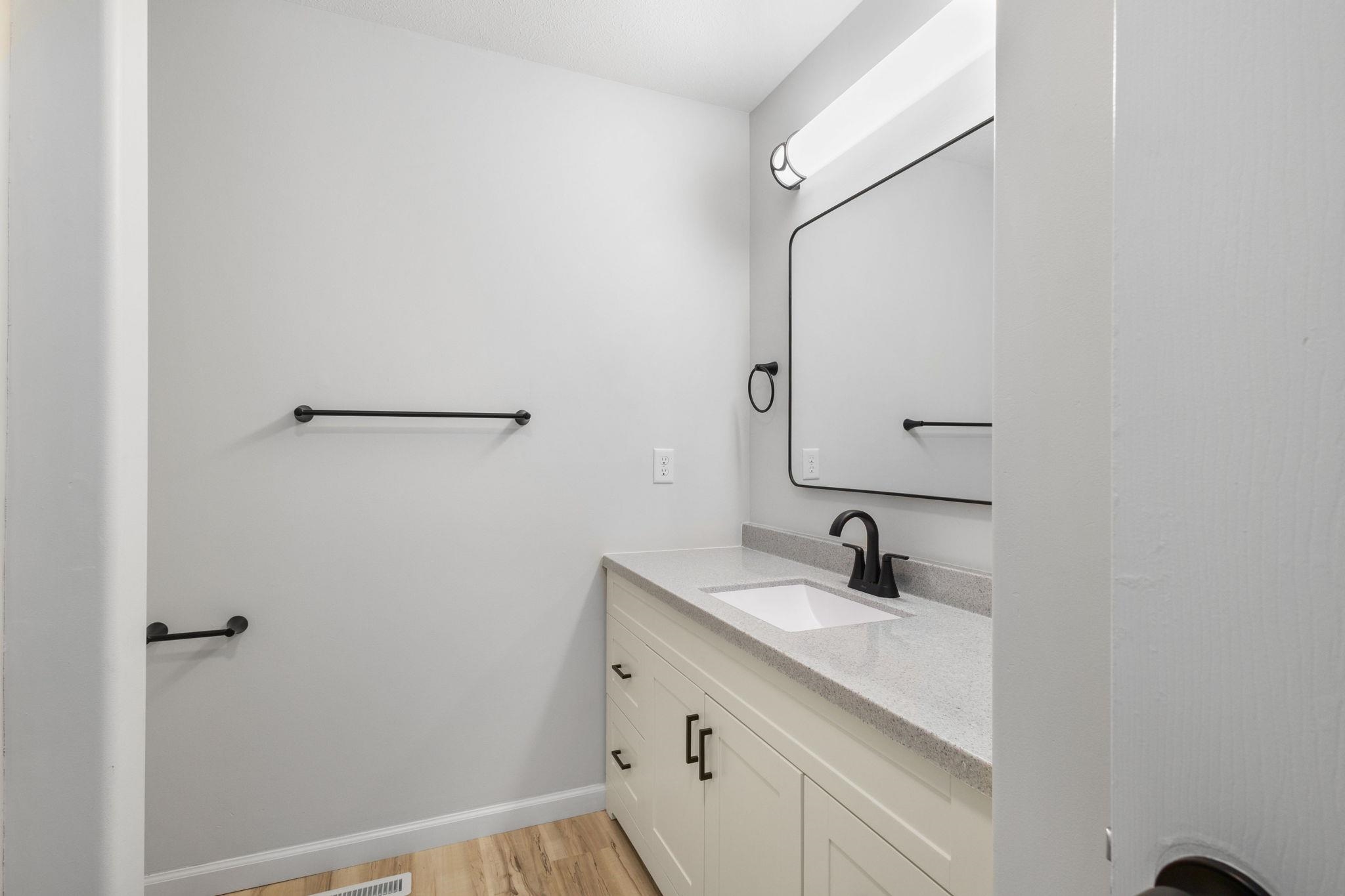 Bathroom with vanity and light wood finished floors