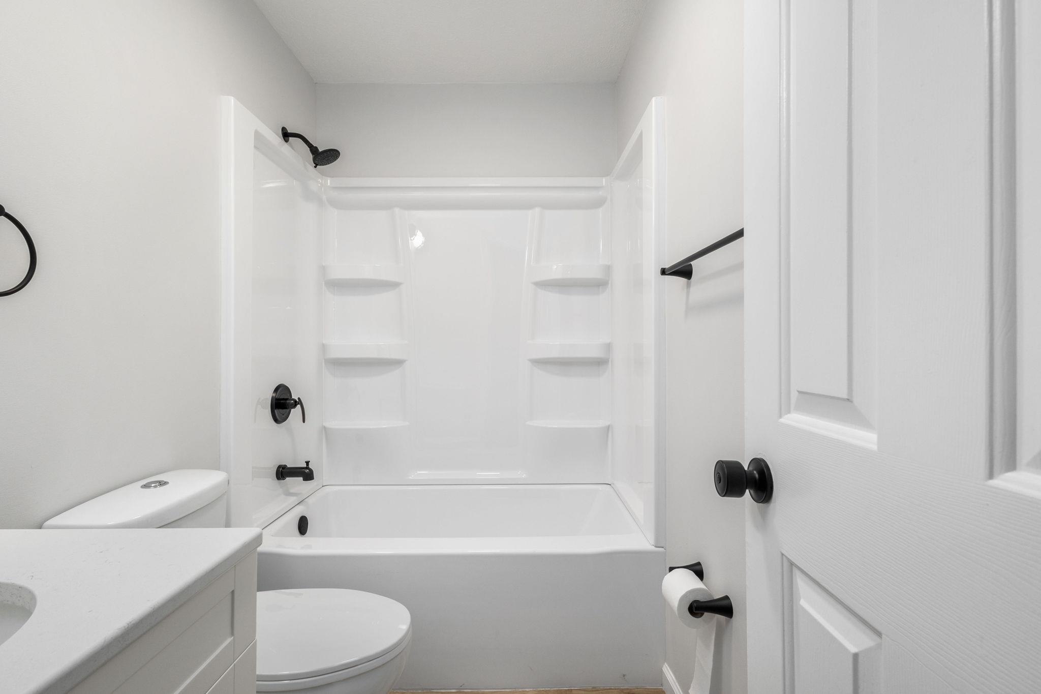 Bathroom with vanity and shower / washtub combination