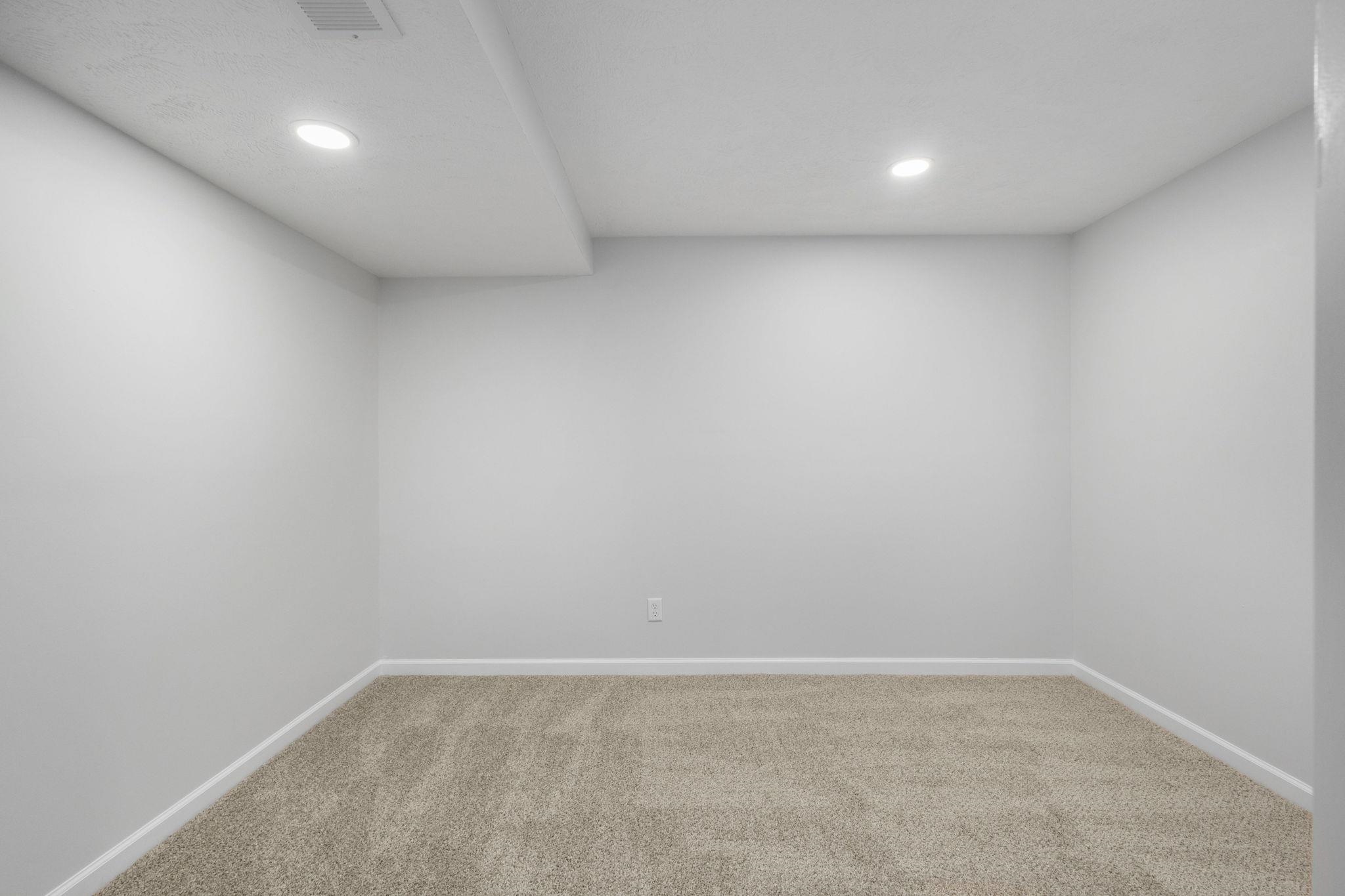 Unfurnished room with recessed lighting and light colored carpet