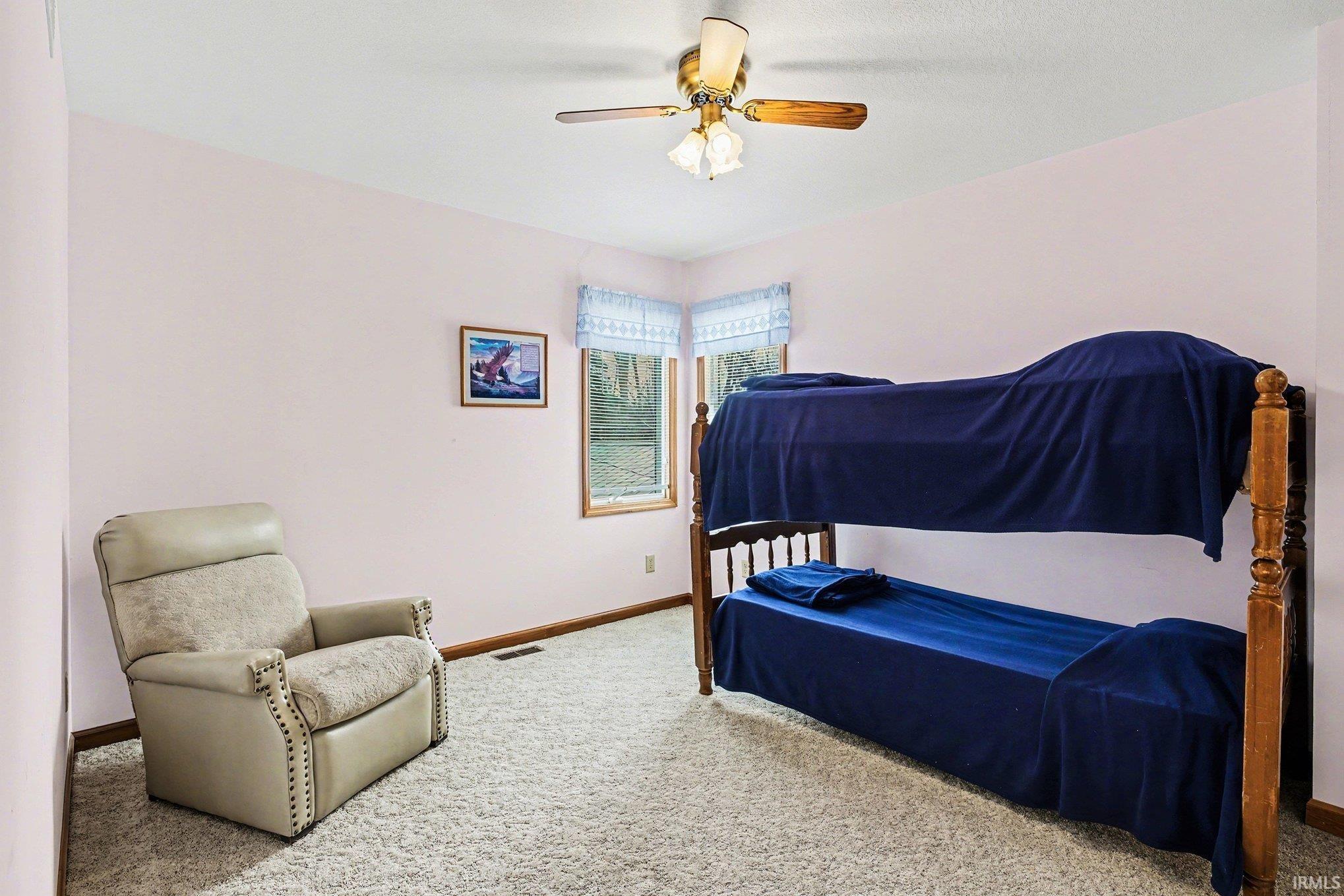 Bedroom featuring light colored carpet and ceiling fan