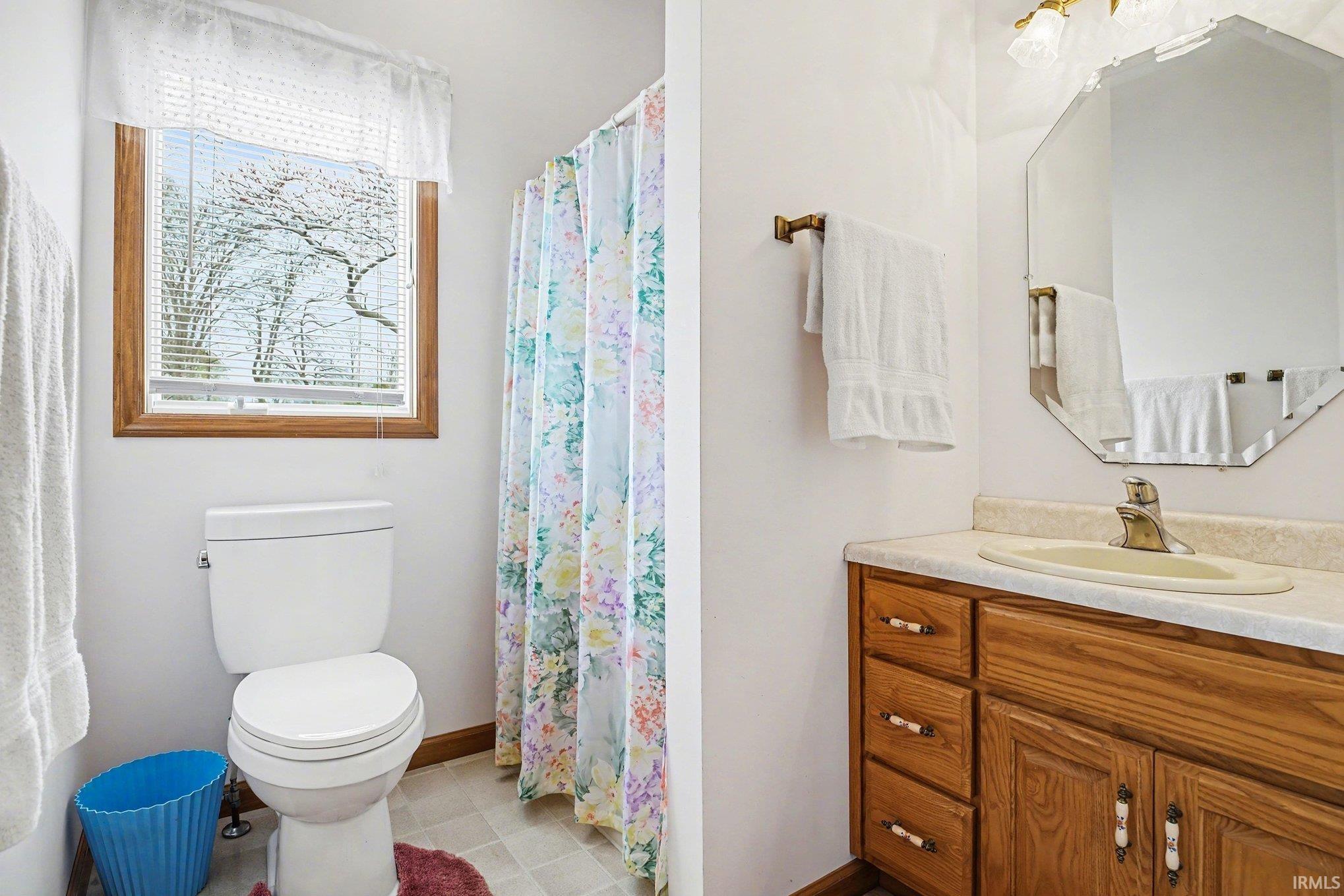Bathroom with vanity and a shower with shower curtain