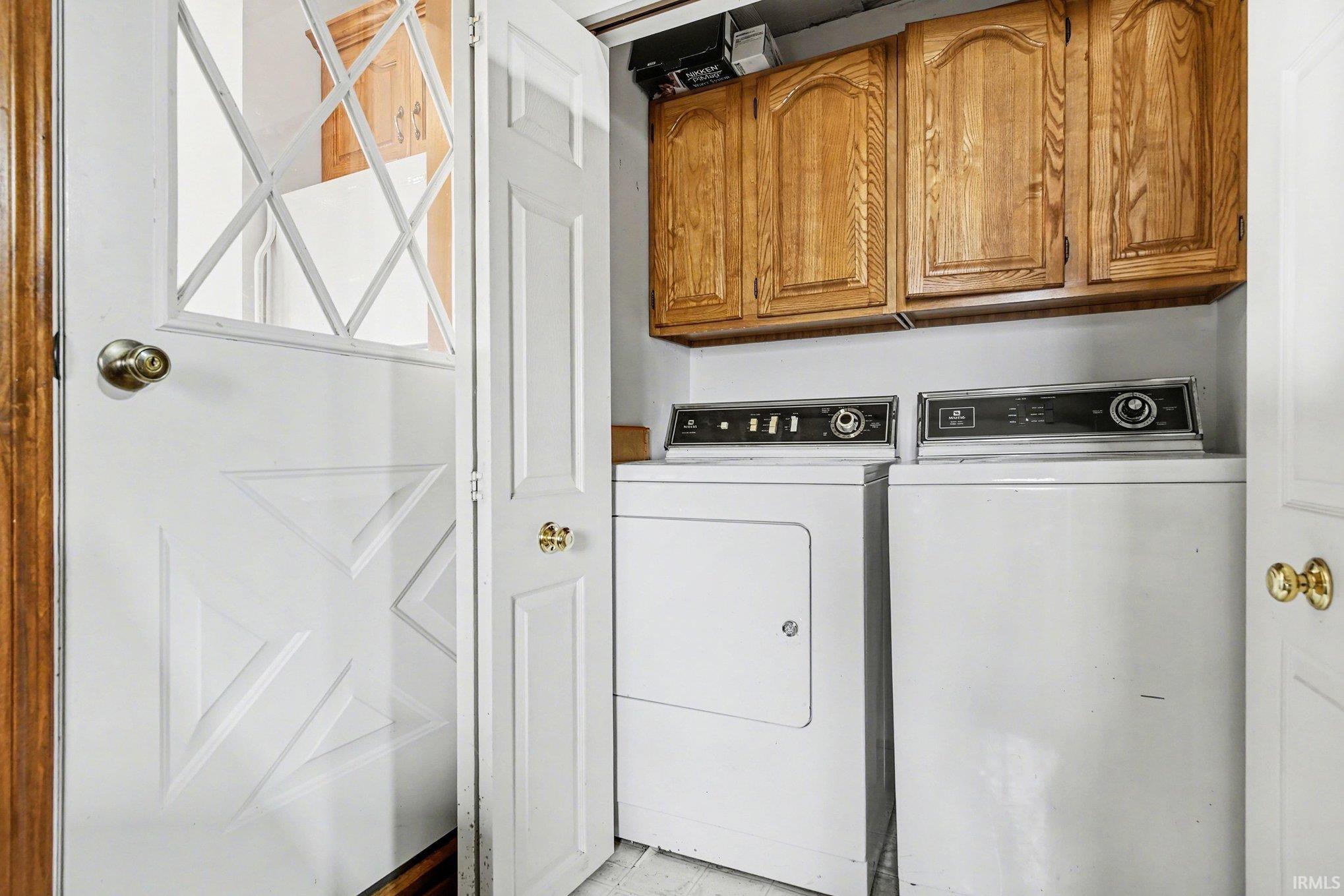 Laundry area featuring cabinet space and washing machine and clothes dryer