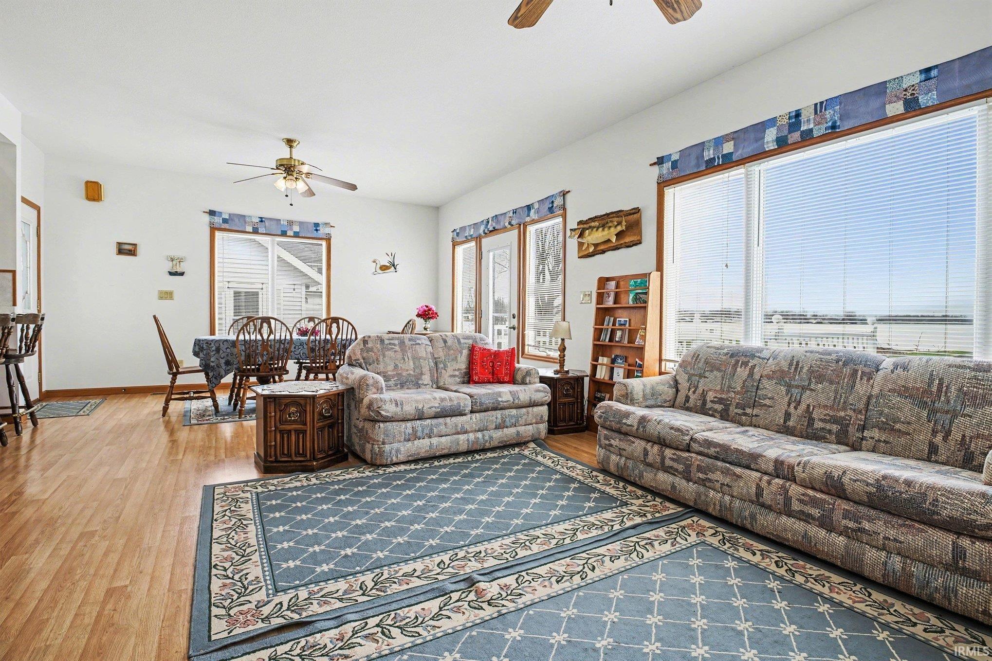 Living room featuring ceiling fan and light wood-style flooring
